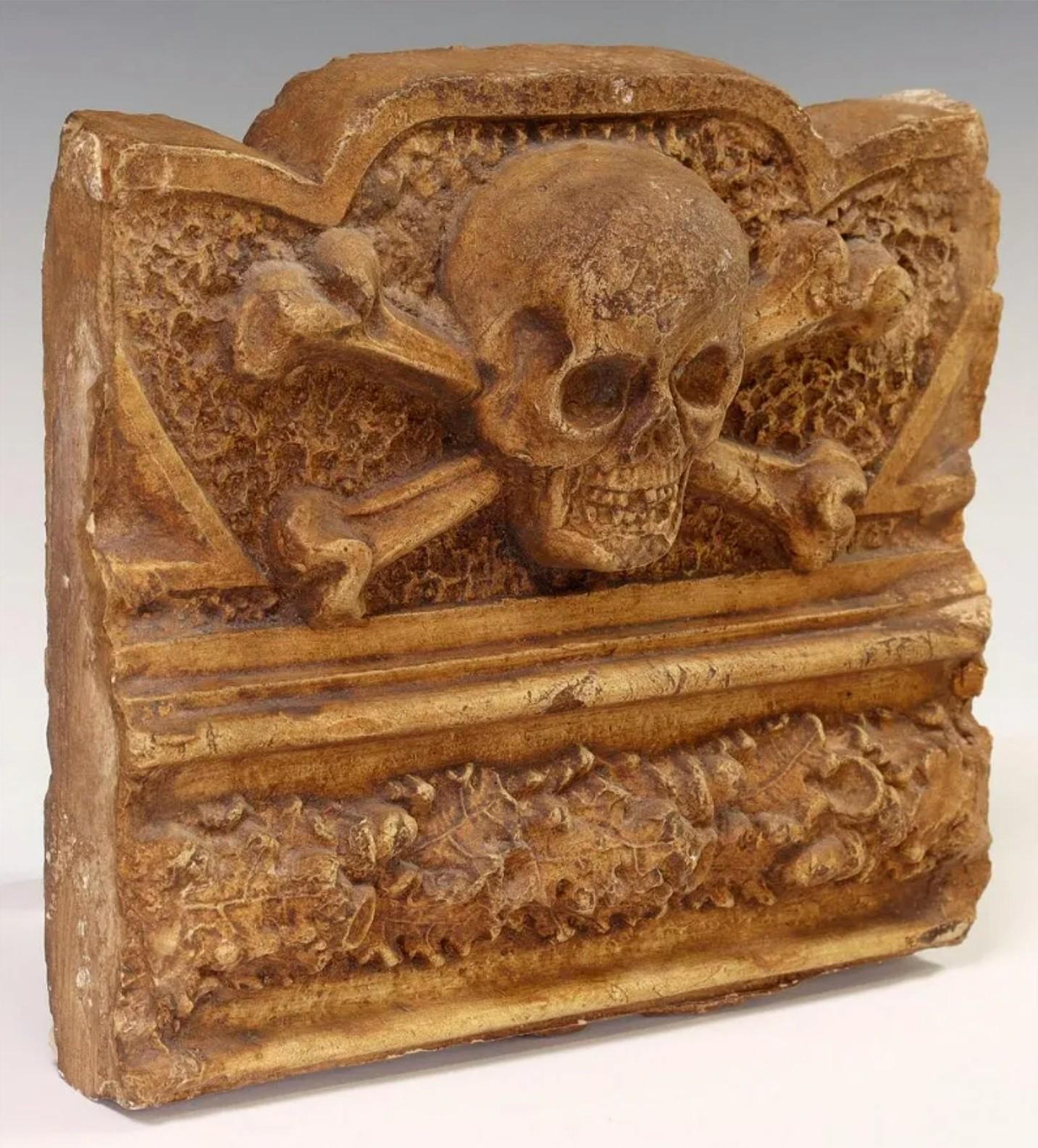 Antique Skull and Crossbones cast architectural salvaged decorative building element, most likely frieze panel fragment. The sculptural Italian Renaissance Memento Mori style architectural ornament crafted of high-quality terracotta, depicting skull