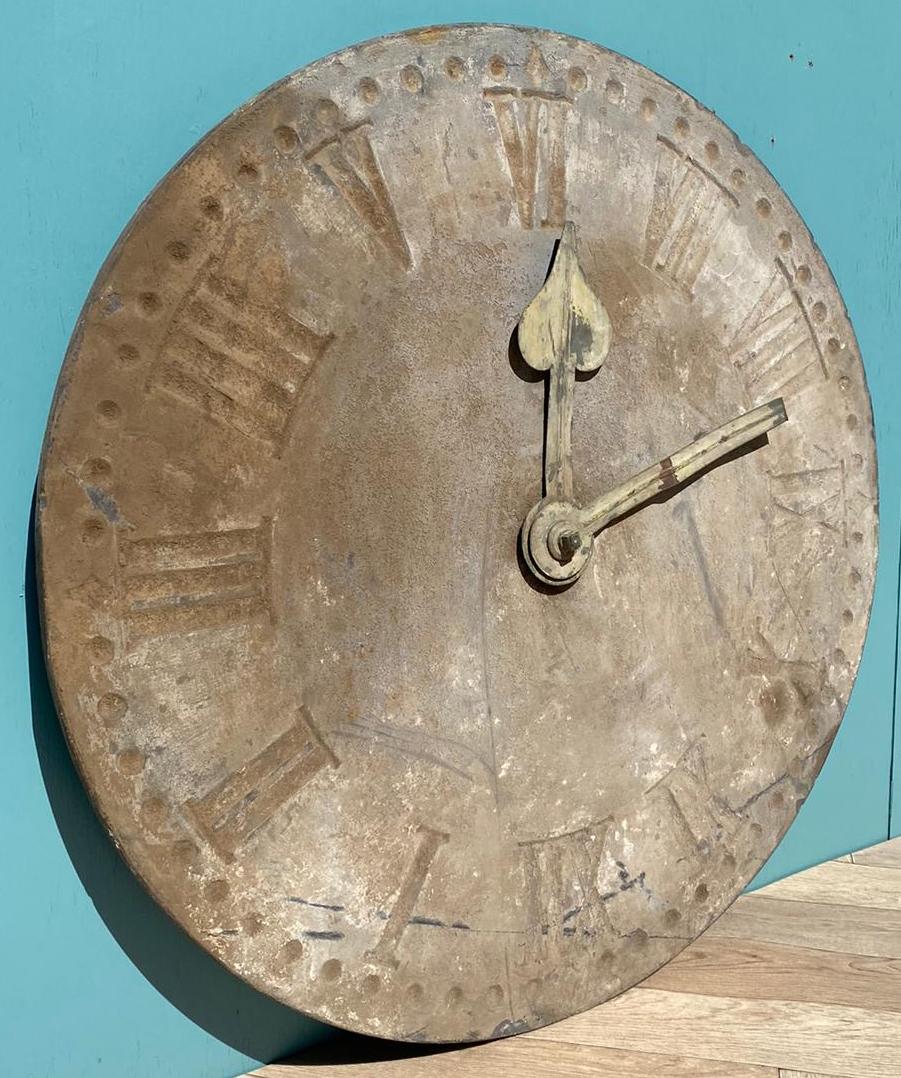 A large antique clock face, made from slate, with copper hands. For garden or interior use.