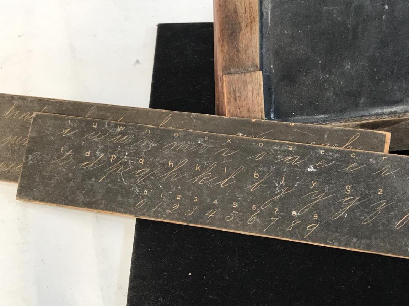 C.C. SHEPARD’S , 1875. Label On Underside. Antique chalkboard that closes, but doesn’t lock. Has plates inside that show script penmanship, capital and lowercase letters, drawing with shapes, faces, and objects. Surface wear appropriate to age,