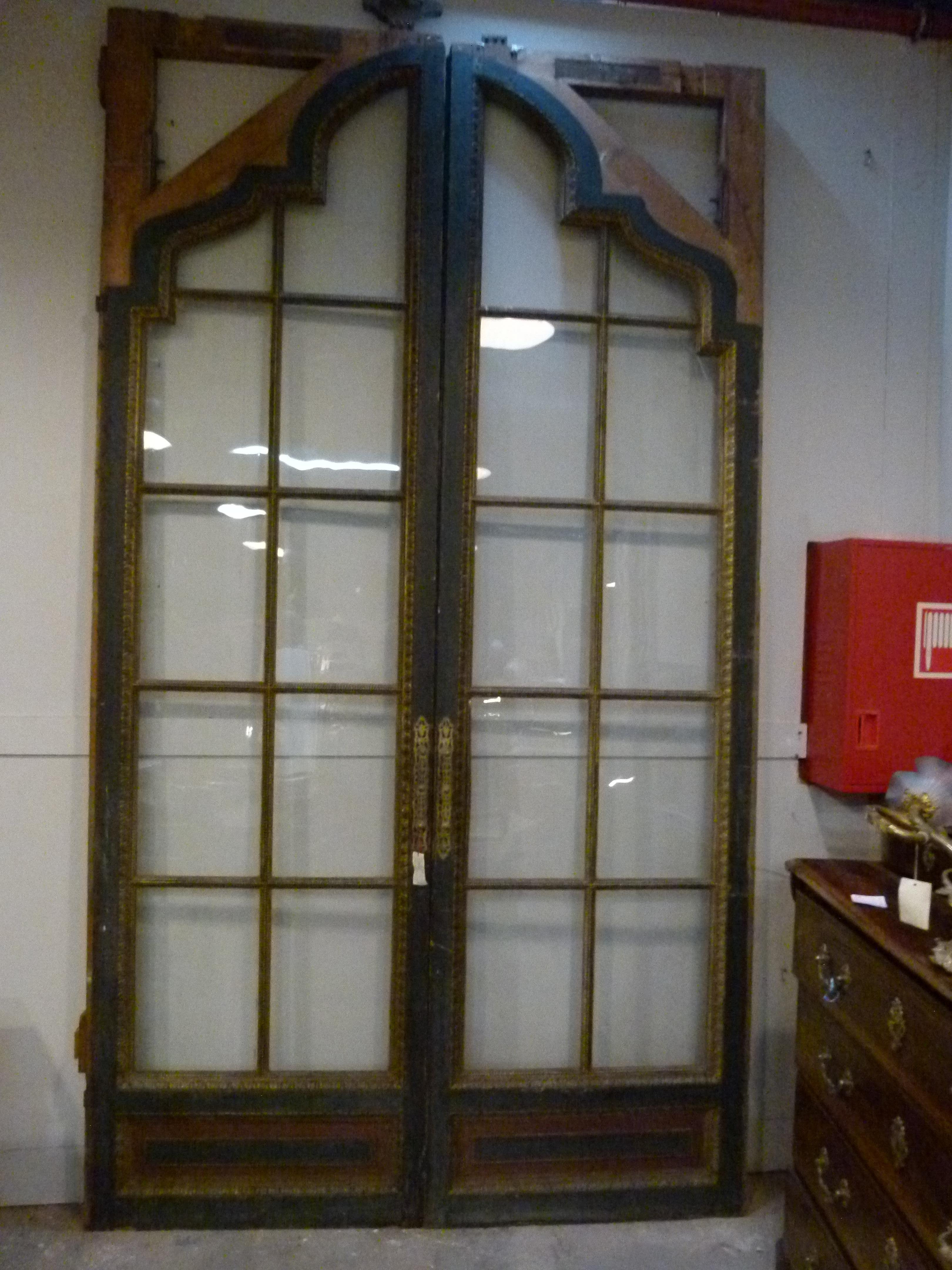 Antique Sliding Huge Double Glass Door with hand carved decorations painted in gold. Ideal for separating two big spaces. In good conditions.
