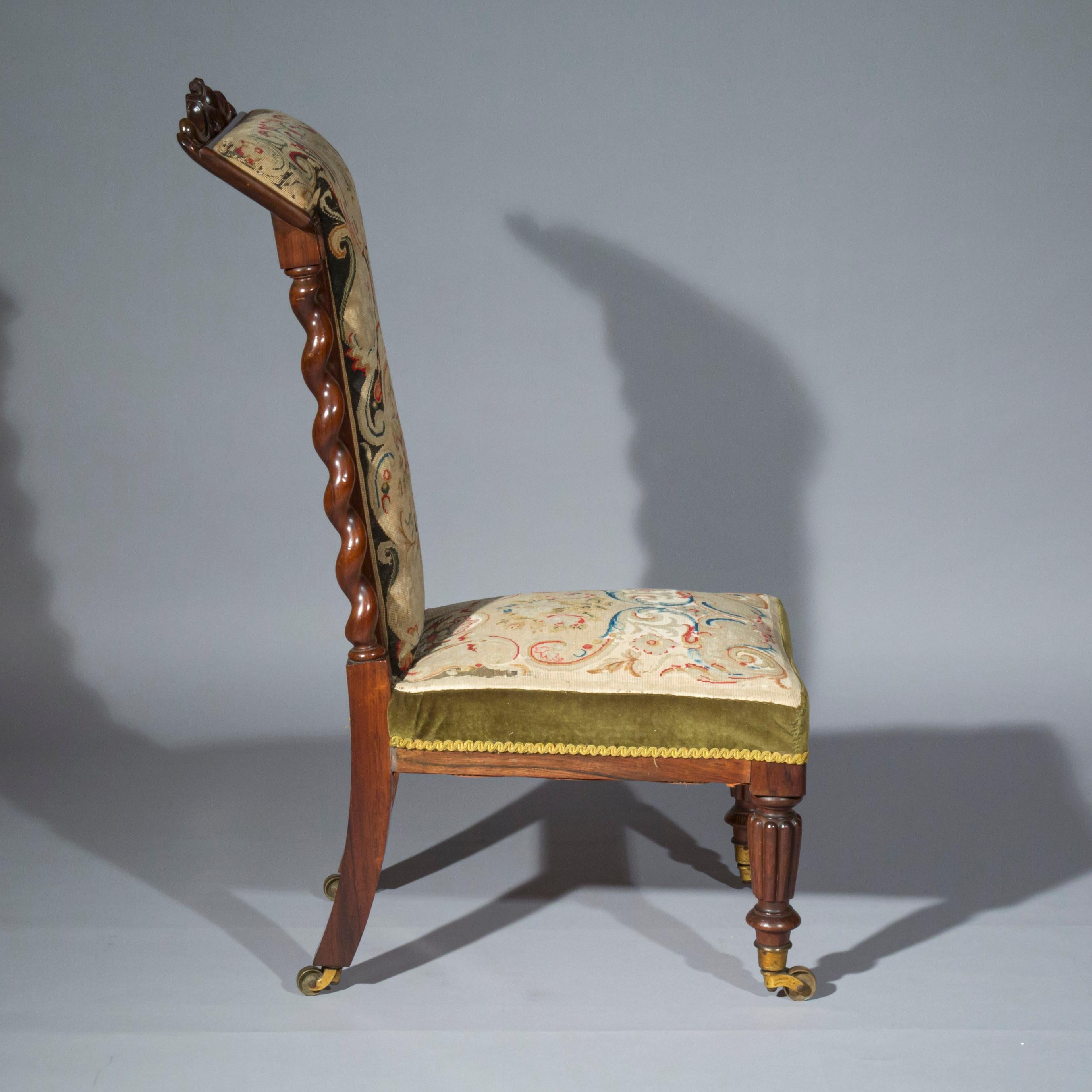 An interesting early 19th century slipper chair of small proportions, retaining original needlework upholstery, English, circa 1835.

The chair provides a useful and versatile low seating, it may be used in a conventional way or straddled, its back