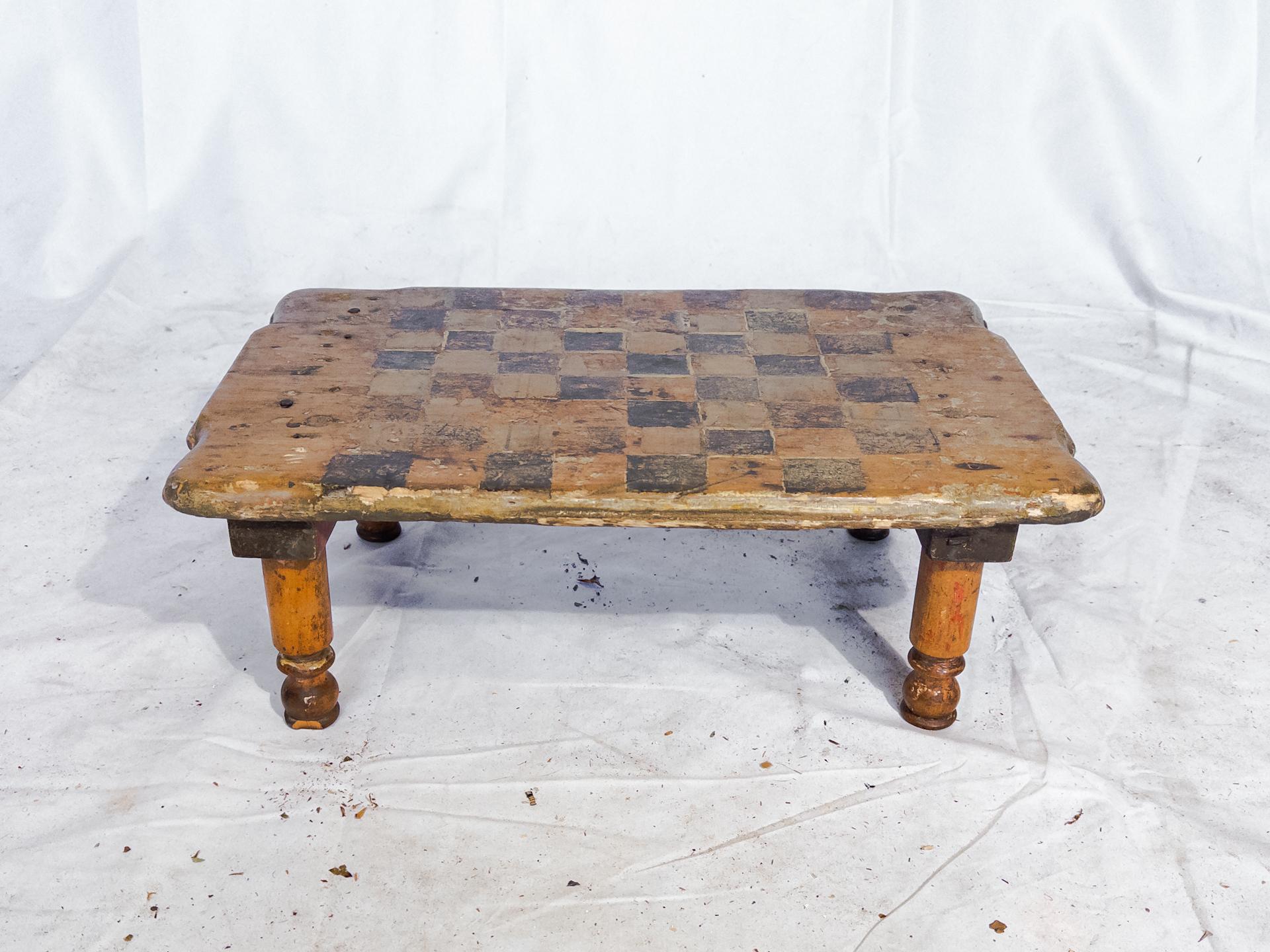 The Antique Small Checkerboard Table/Chess Board is a charming piece sourced from New England, boasting a rich history and timeless elegance. Standing at a diminutive height of 6.5 inches, this table exudes quaintness and craftsmanship. Its compact