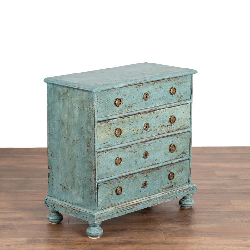 This delightful antique chest of drawers from the early 1800's has been given new life with a recent layered blue painted finish. Note in the photos the slight distressing which compliments its age and brings out touches of the natural wood beneath.