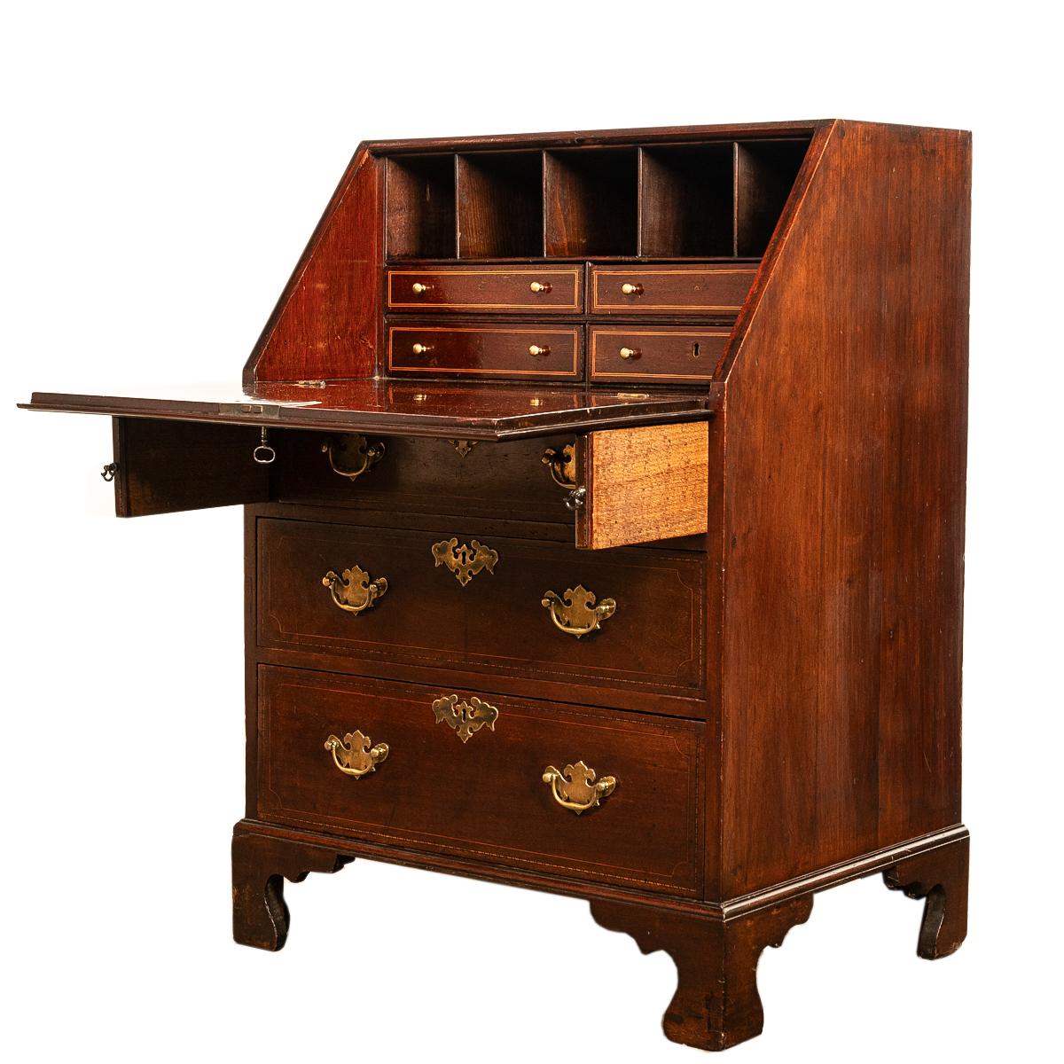 An unusually diminutive Georgian inlaid mahogany bureau, slant front desk, circa 1780.
This is a rare & unusually diminutive Georgian mahogany bureau, the fall front with a brass escutcheon and original key, the front having boxwood & ebony string