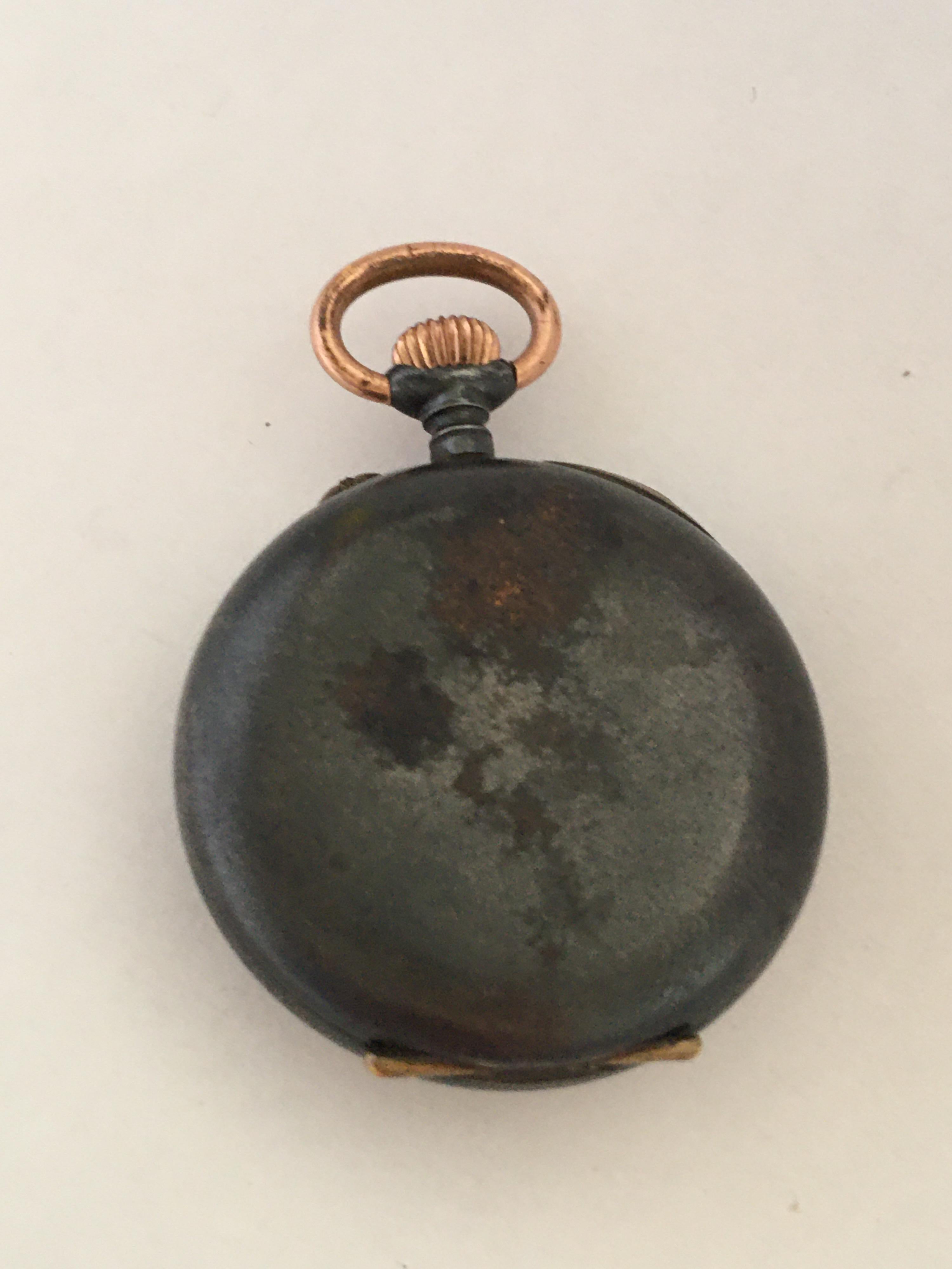 This beautiful antique  small pocket watch is working and ticking well. The back cover case is a bit tarnished.