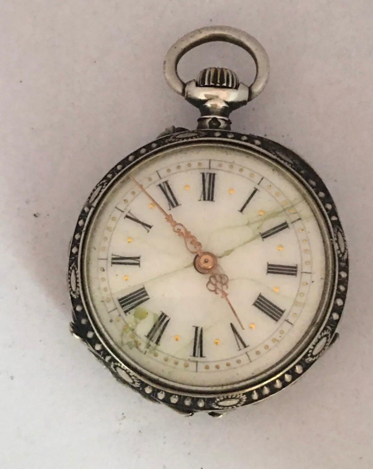 This beautiful 30mm diameter (excluding the crown)small ladies fob / pocket watch is Not working. The balance wheel is broken. Visible signs of ageing and wear with cracks on the white enamel dial as shown. Selling for spares or possible repair.