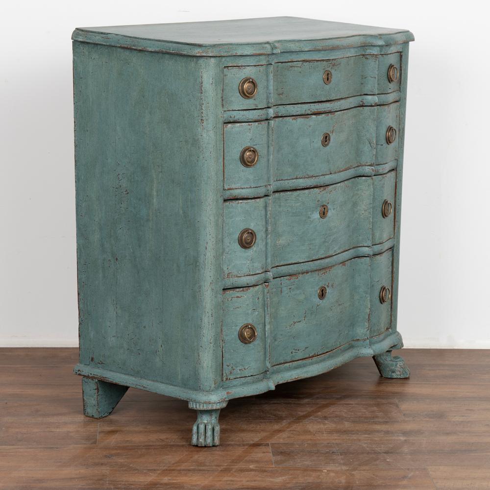 Danish small-sized chest of drawers or nightstand in blue painted pine.
Curved rococo front with four drawers resting on front claw feet. 
The four drawers are each fitted with bronze keyhole brackets and two drop pulls.
Restored, newer