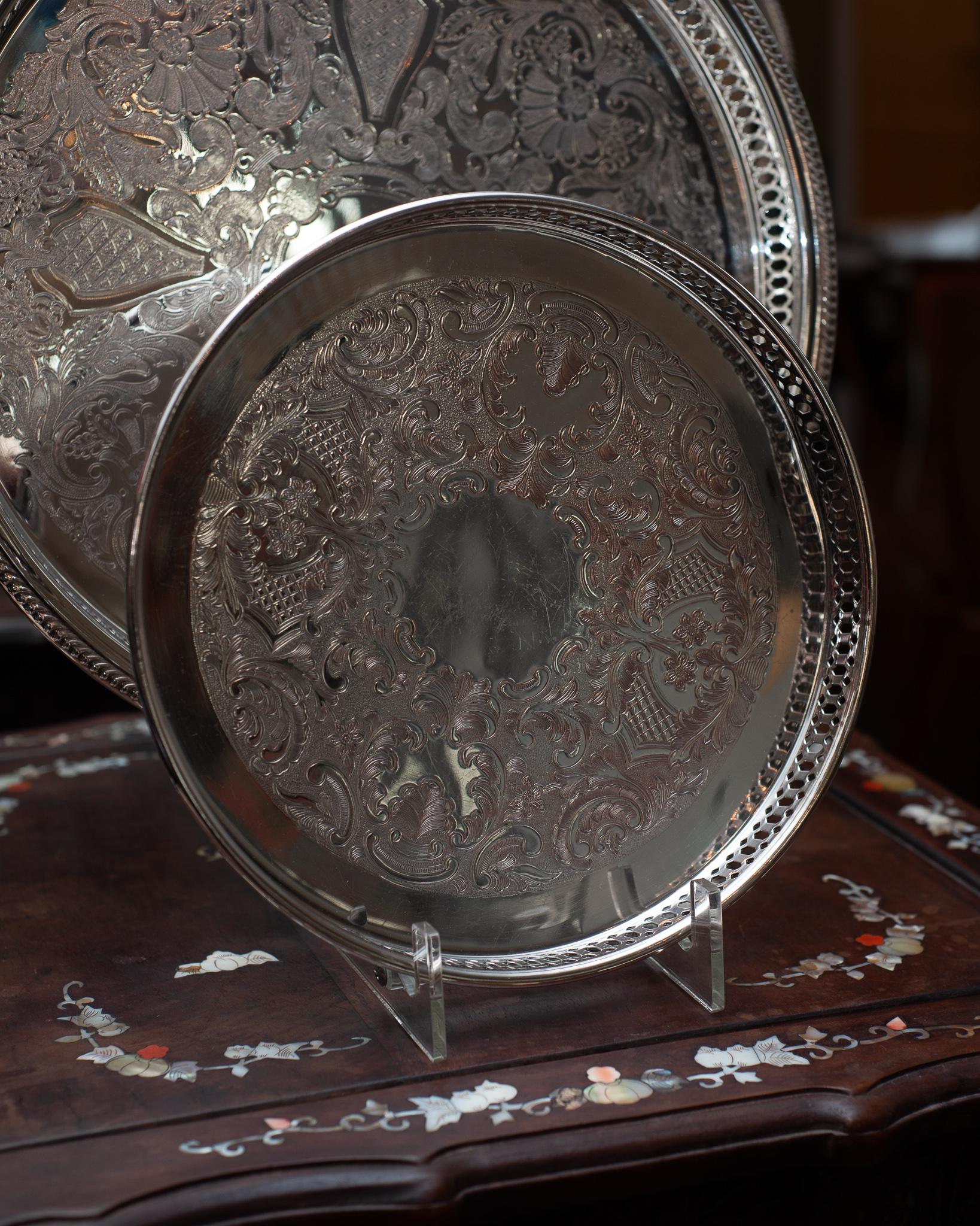 An antique small silver plate round serving tray with gallery rim.