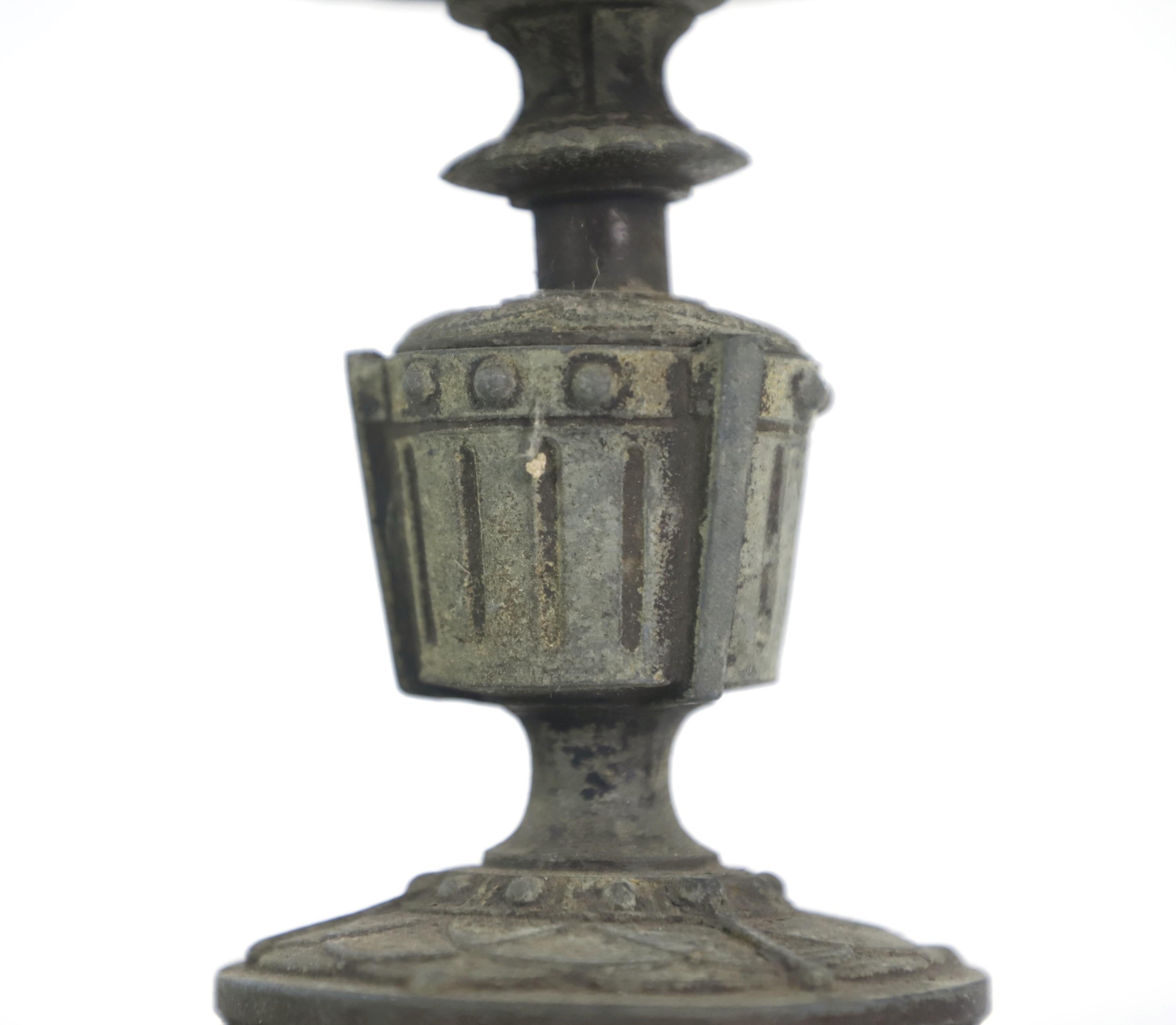 Early 20th century French antique oil lamp stand with three legs. Can also be used as a candelas holder or a very small planter. Ornate detailing around the perimeter of the top. It is stamped on the bottom. Features original patina. Please note,