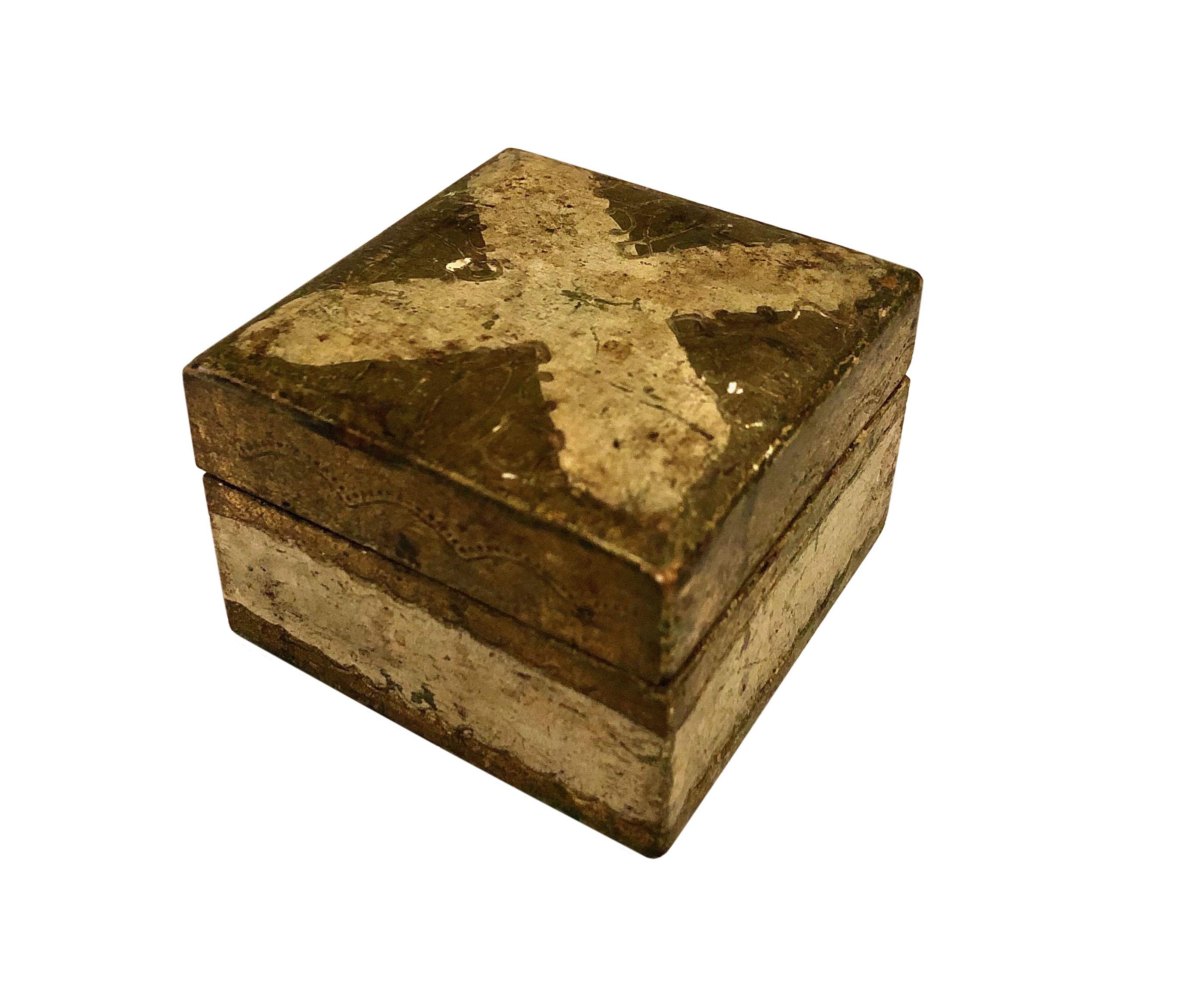 A small turn of the century Italian Florentine box with an X design on top.
