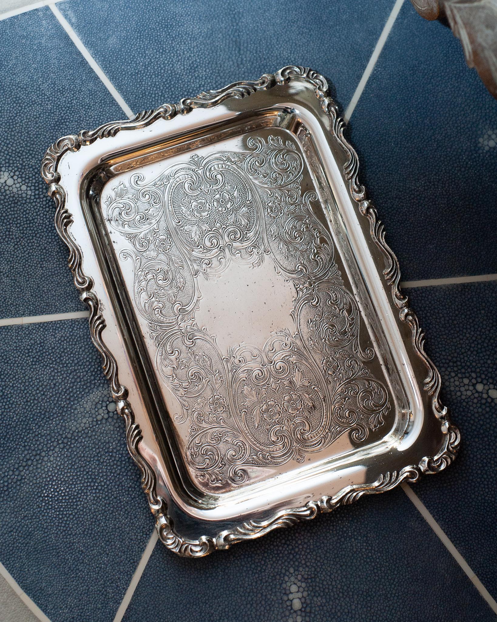 An antique small silver plate rectangular serving tray with ornate border and interior engraving by WM A Rogers. Silver plated copper.