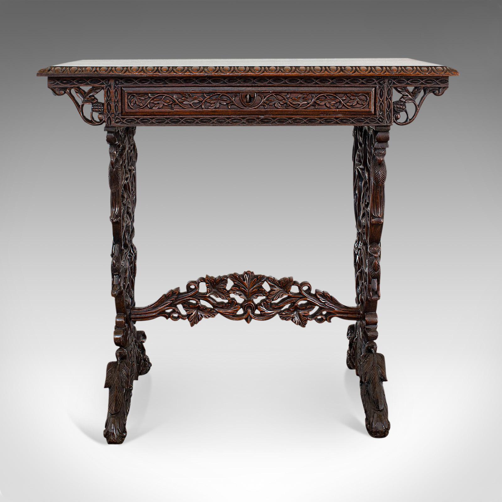 This is an antique small writing desk. An Asian, rosewood side or lamp tale dating to the early Victorian period, circa 1850.

Rare and hugely ornate and striking small desk
Displays a desirable aged patina
Rosewood resplendent with fine grain