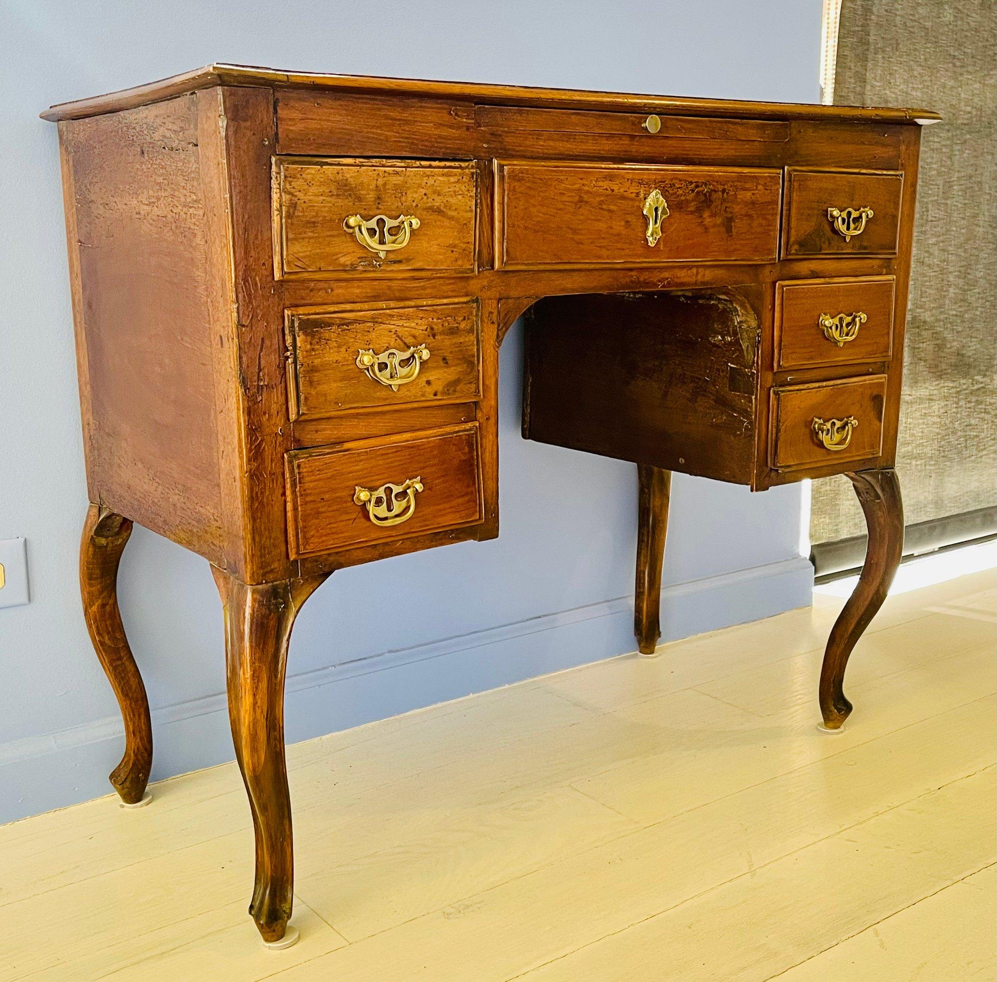 Antique small writing desk on cabriole legs with original brass hardware. Desk features 7 drawers and pull out slide on the front.

Dimensions
32.5