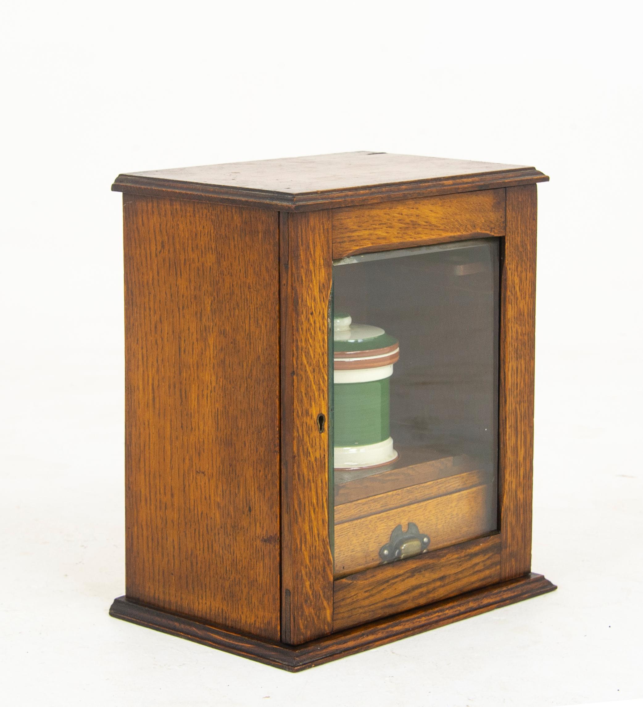 Antique smokers cabinet, antique humidor, Victorian, Scotland, 1900, antique furniture, B1290

Scotland 1900
Solid oak with original finish
Single bevelled glass door
Fitted with single drawer interior and china humidor
Flanked by pipe