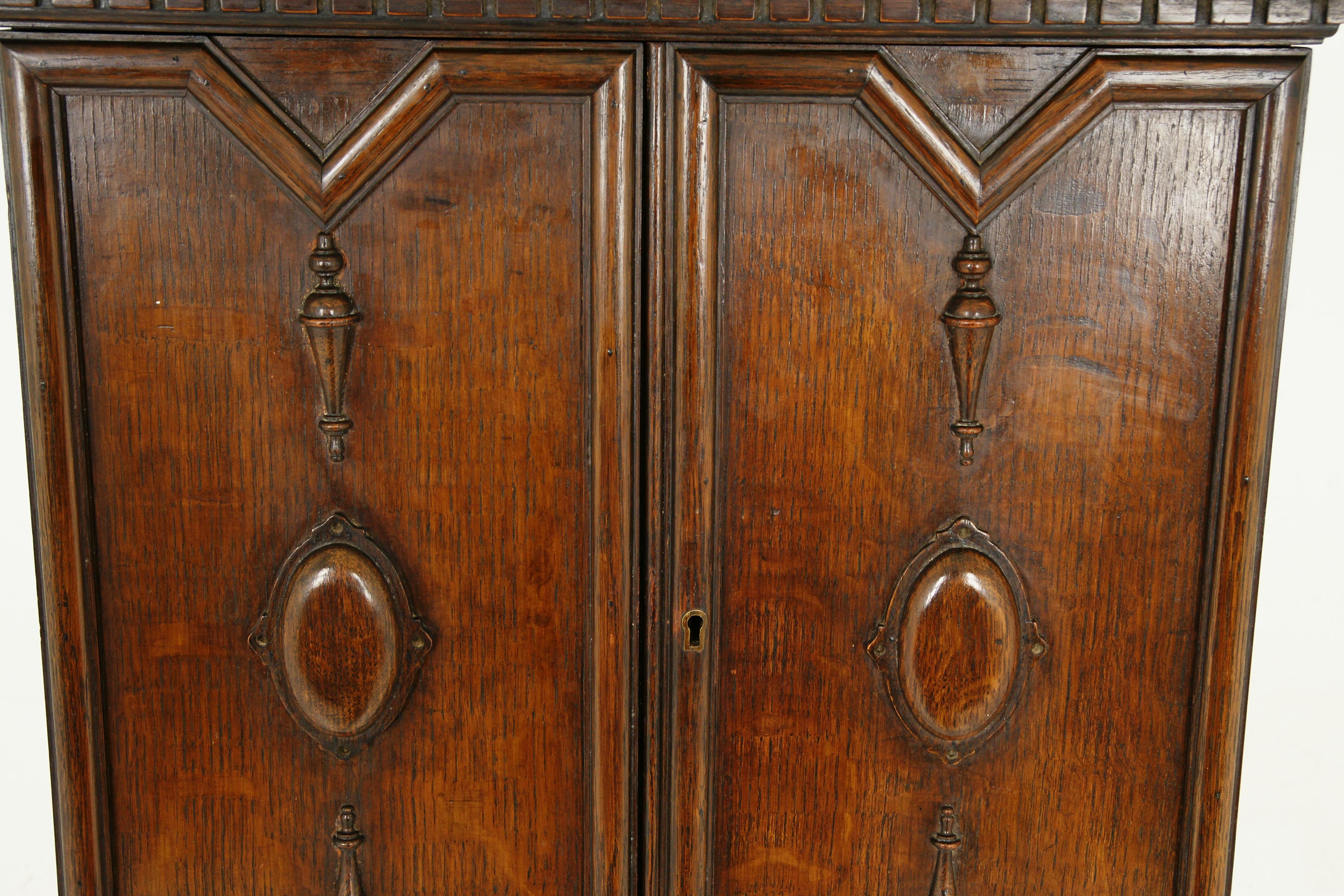 Antique smokers cabinet, carved tiger oak, humidor, pipe rack, Scotland 1910, B2385

Scotland, 1910
Solid oak
Original finish
Rectangular moulded top
Shaped pediment to the top back
Geometrical paneled doors
Opens to reveal a pair of fixed