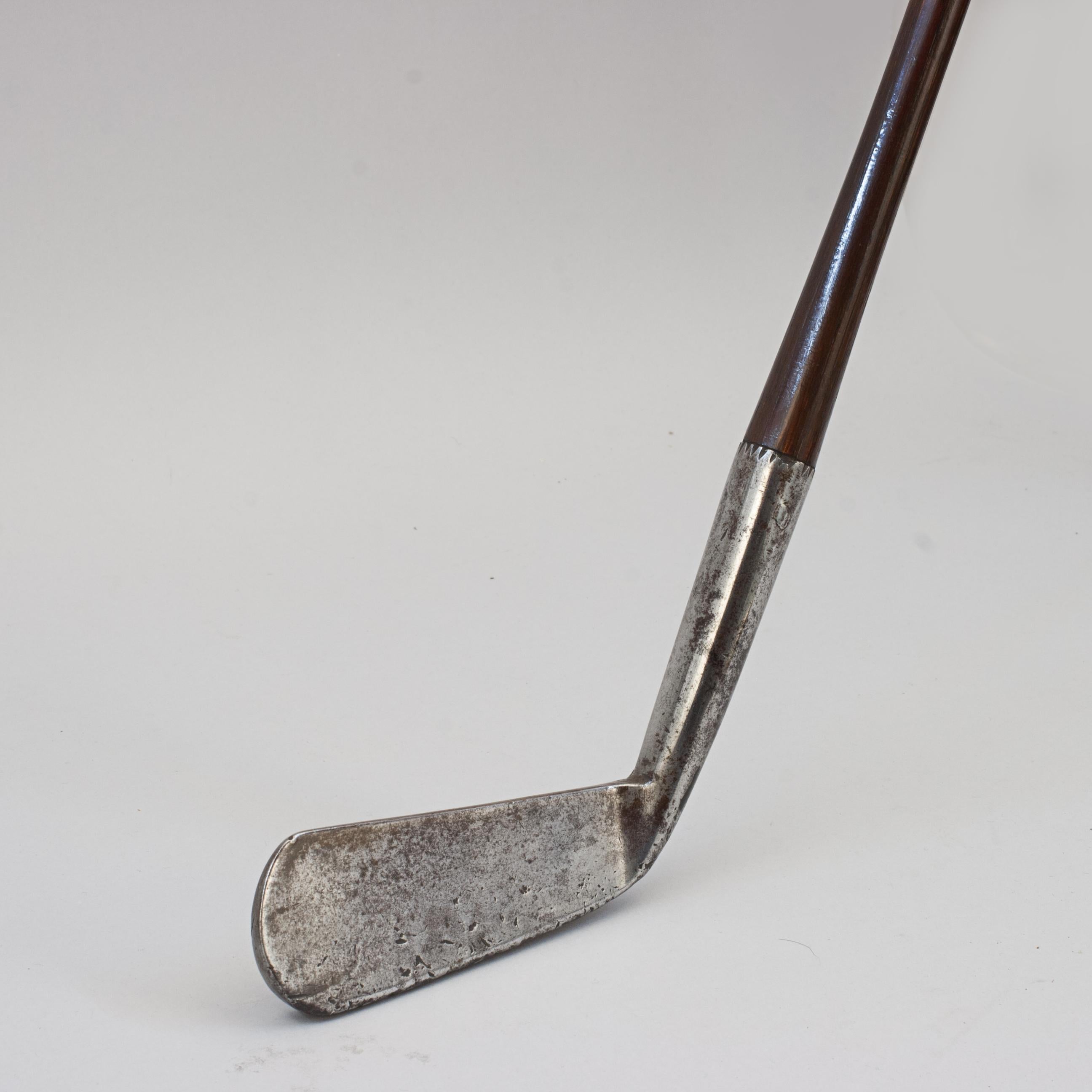 Antique Smooth Face Cleek, Golf Club.
This early hickory shafted iron has a smooth face, original hickory shaft, that has been shortened, and later polished leather grip. This is a fine example of a fairly early lofting iron. The maker is unknown as