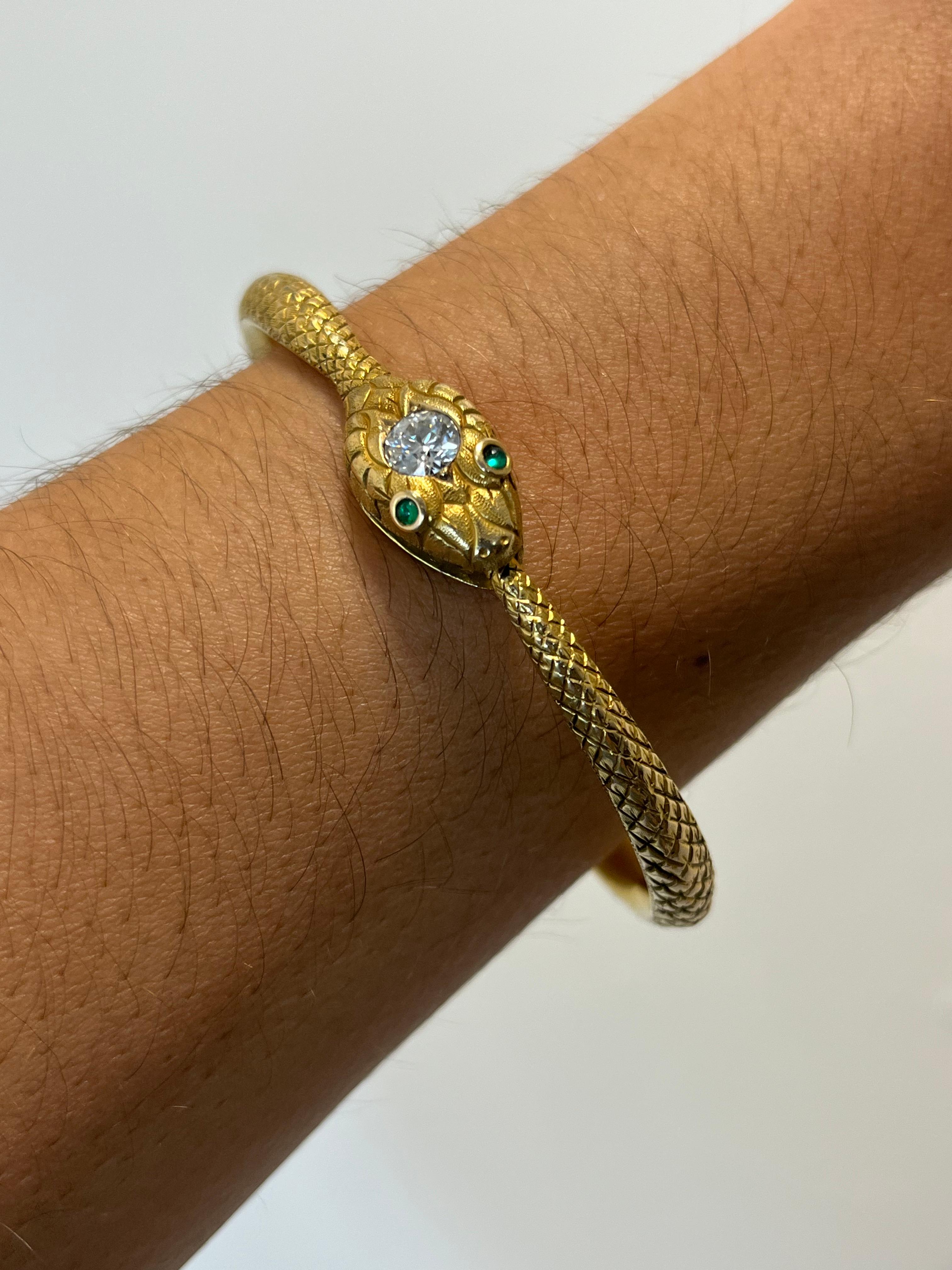 A gorgeous antique snake bracelet featuring a single 0.70ct natural round diamond (VS1 clarity, H color) on its head and two emerald eyes. The bangle opens by suppressing a discrete button on the snake’s body and pulling the tail from its mouth.
