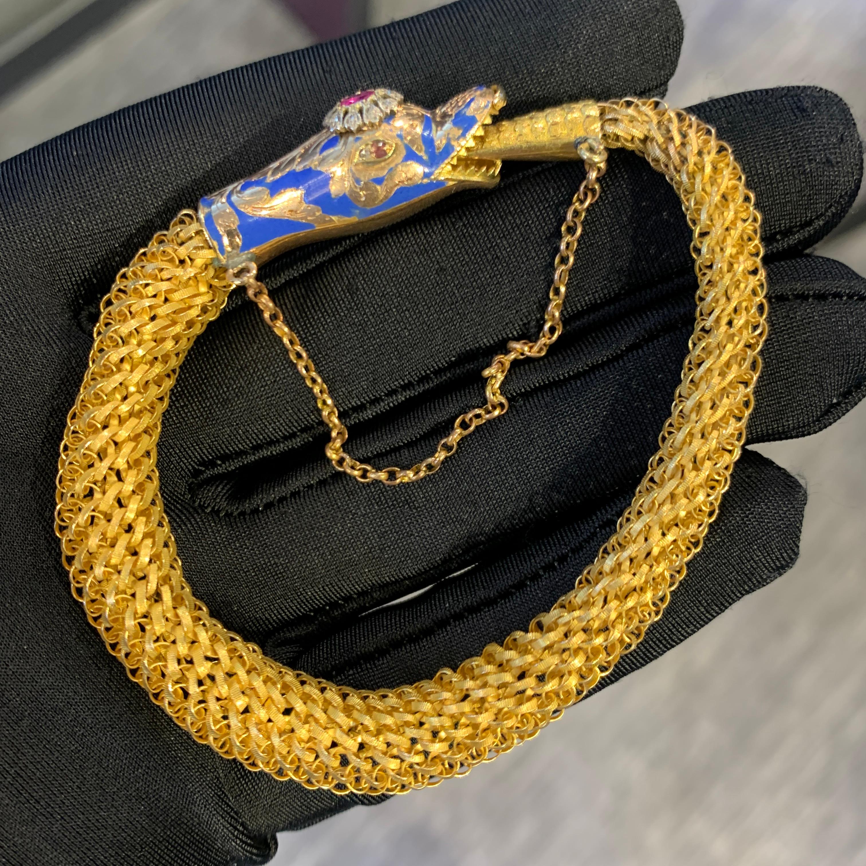 Antique Snake Bracelet

A 14 karat gold mesh bracelet featuring a serpent's head and tail clasp. The snake head is set with blue enamel, diamonds and an oval shaped ruby, while the eyes are each set with a diamond and an amethyst.

The Ouroboros