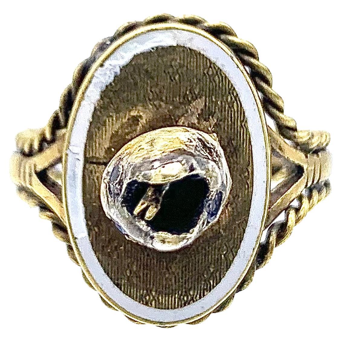 This very unusual snake ring features a double sided face, with a tongue, one side shows sapphire eyes , the other diamond eyes. The head is set in an oval ring head decorated with white enamel.  