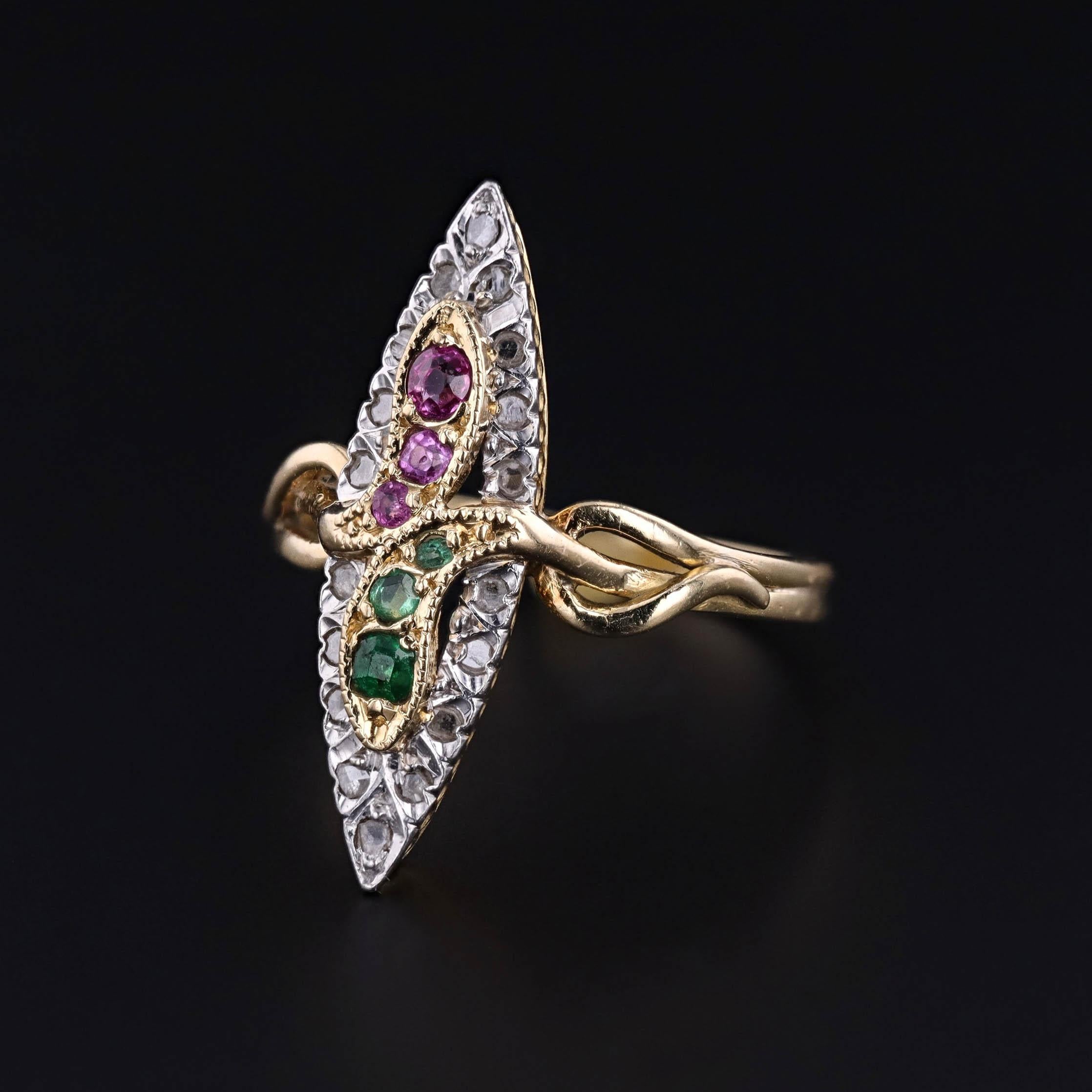 Antique 18K Gold Double Serpent Ring with Ruby, Emerald & Diamond – Circa 1900

This striking antique ring, crafted around 1900, features a dramatic double-serpent design, coiling upward with intertwined heads—one crowned with vibrant rubies, the