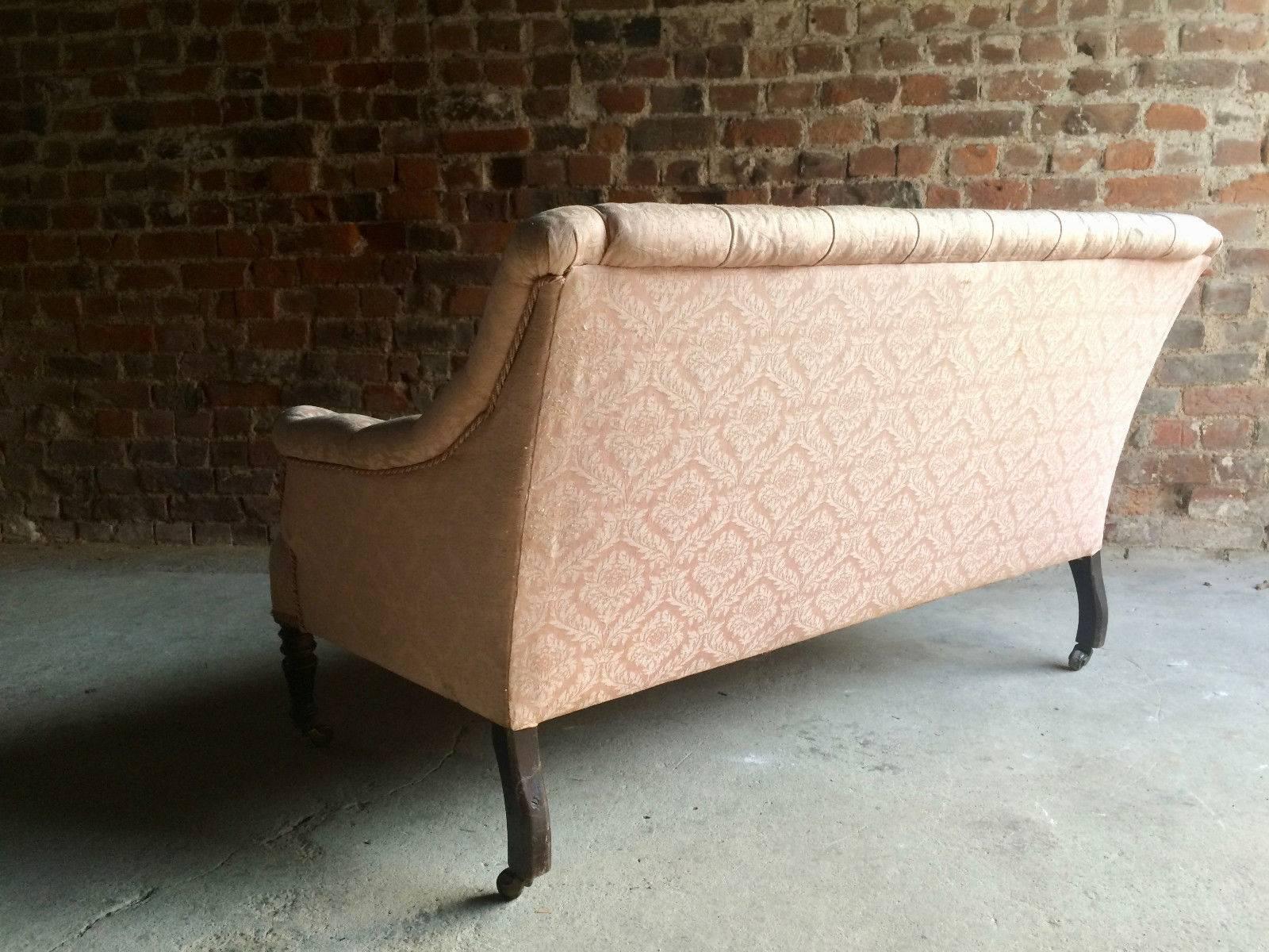 A magnificent 19th century Victorian mahogany framed salon sofa settee circa 1870, button back two seater upholstered in pink satin damask fabric with turned front legs terminating in brass casters, the sofa is offered in excellent condition with