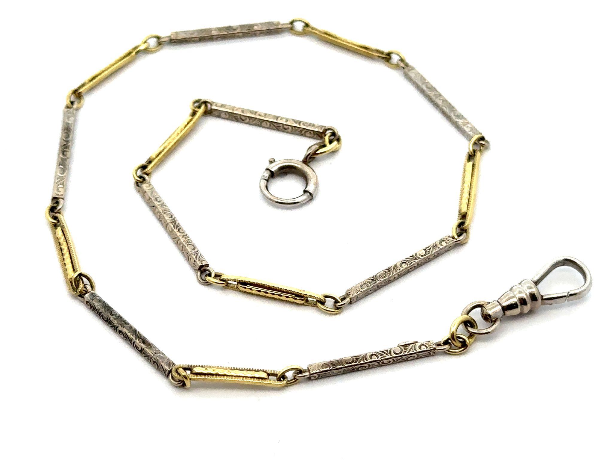 Material: Solid 14 Yellow & White Gold
Weight: 9.74 Grams
Chain Type: Textured Open Links & Engraved Scroll Work Bar Links
Chain Length: 13 Inches
Chain Thickness: 1.7mm (at the bar links)
Chain Width: 2.4mm (at the open links)
Clasp: Spring Ring &
