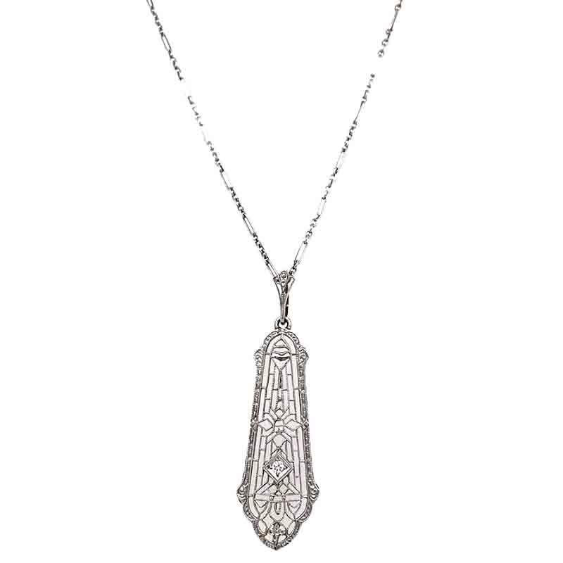 Excellent condition. This solid 14k white gold antique necklace features a filigree pendant that measures approximately 1.50 inches long X 0.50 inches at its widest point. It holds a genuine accent diamond in the center. The chain measures 15 inches