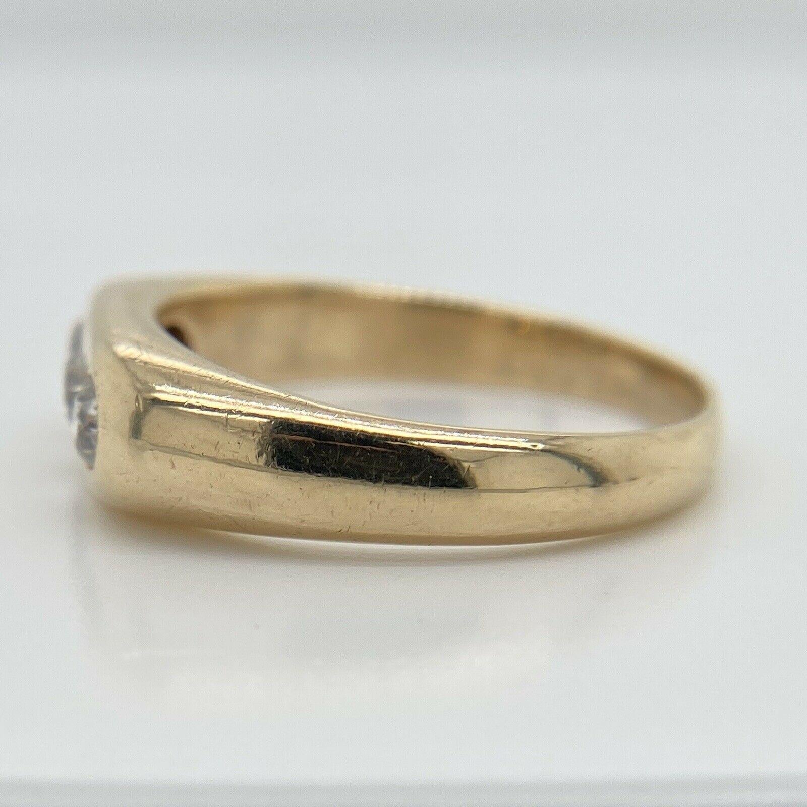 This antique solid 14K yellow gold ring features three genuine old mine cut diamonds that weigh approximately 0.60CTTW and are H/VS2-SI1 quality. The top of the ring is 6.45mm wide, the ring is a size 10.25 and weighs 6.3 grams. 