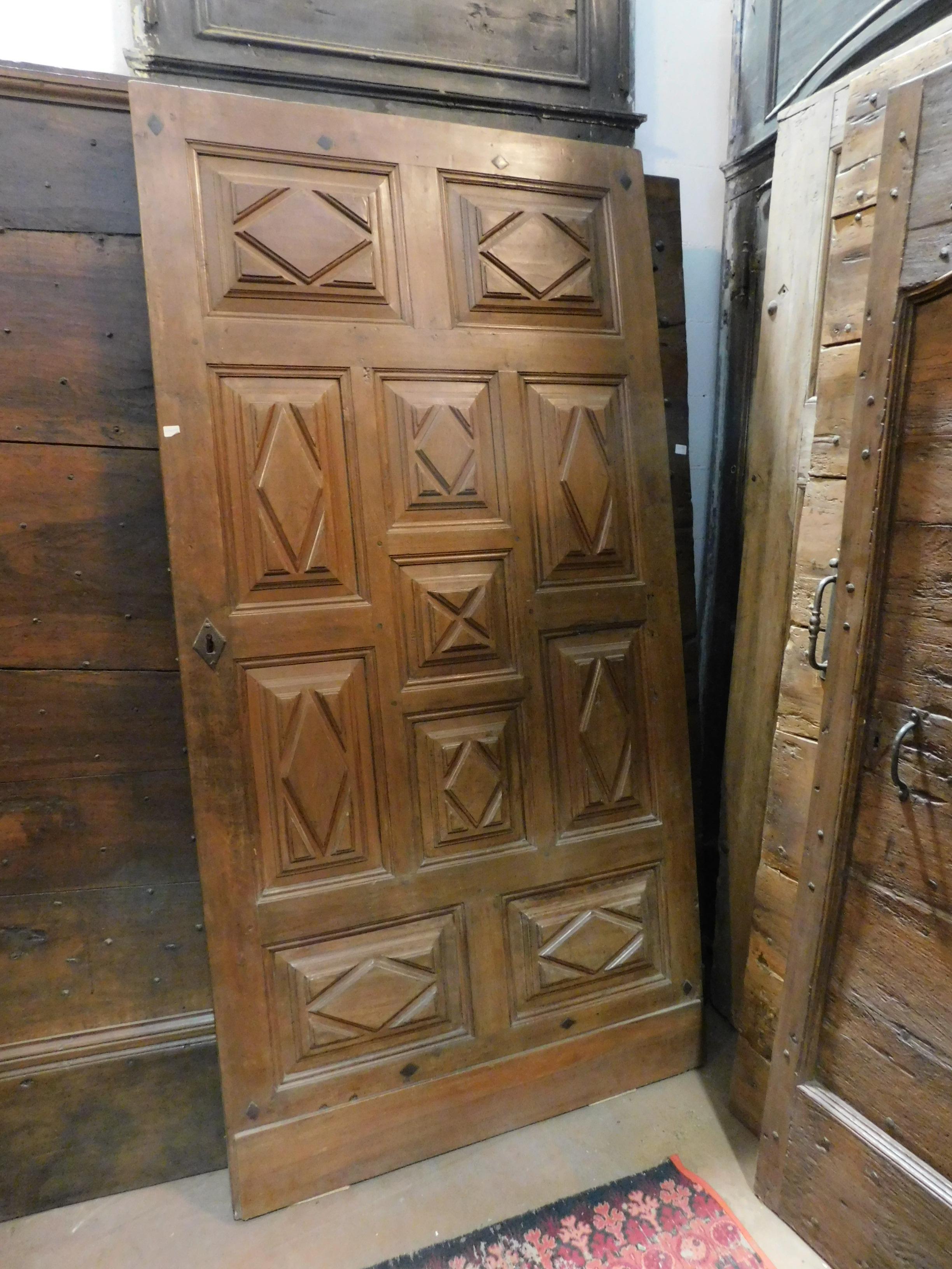 Ancient main door, for entrance, in solid walnut, hand carved with many panels containing lozenges typical of northern Italy of the 17th century.
Very beautiful and of great visual effect, from shatterproof safety since it is very deep, well