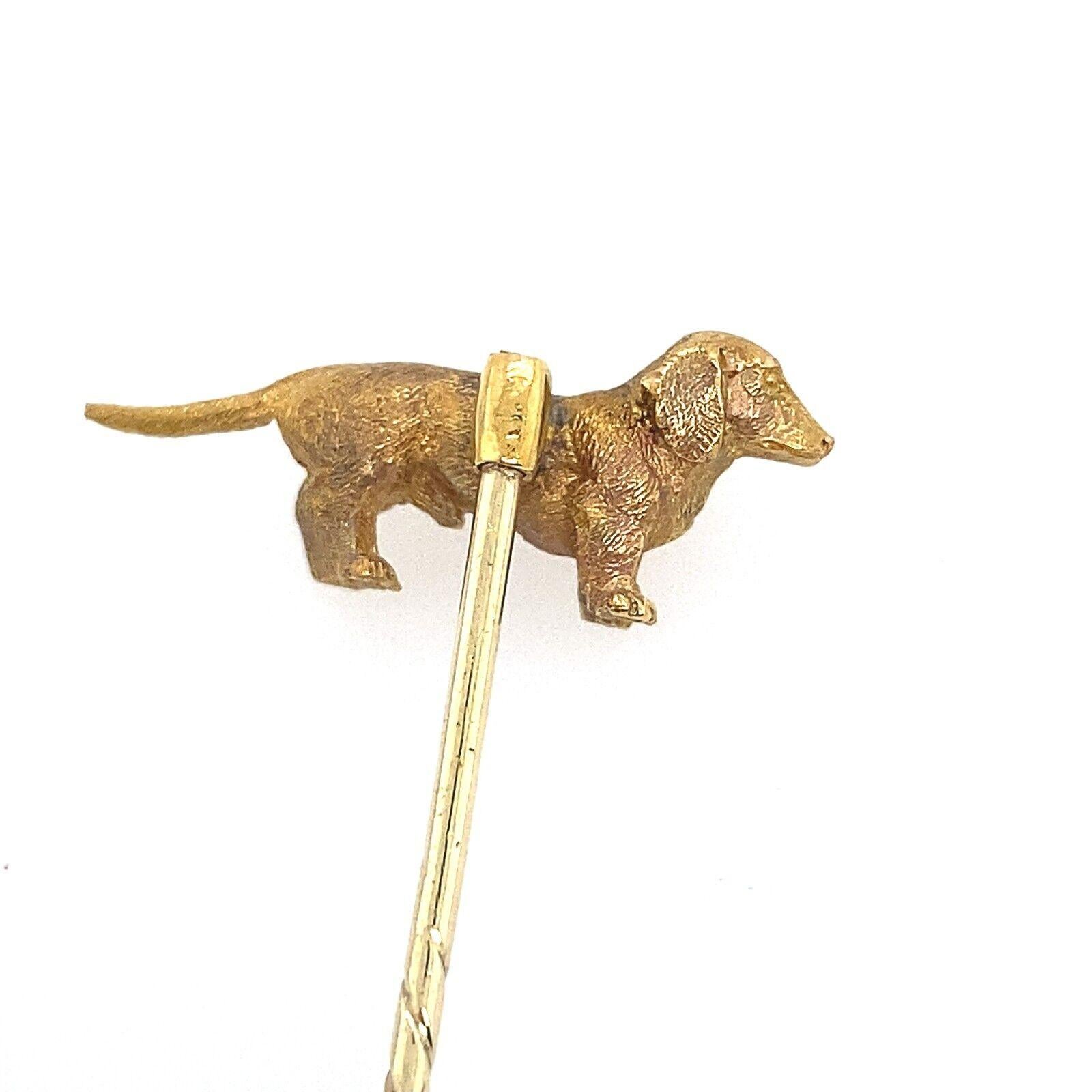 This is a very unique and unusual stick pin. 
It is 21ct gold at the top of the pin is a dachshund figure 
and 11ct gold for the pin.
The dachshund is approx. 23.60 mm long..

Additional Information:
Total Gold Weight: 4.4g
Dimension: 57.50mm x