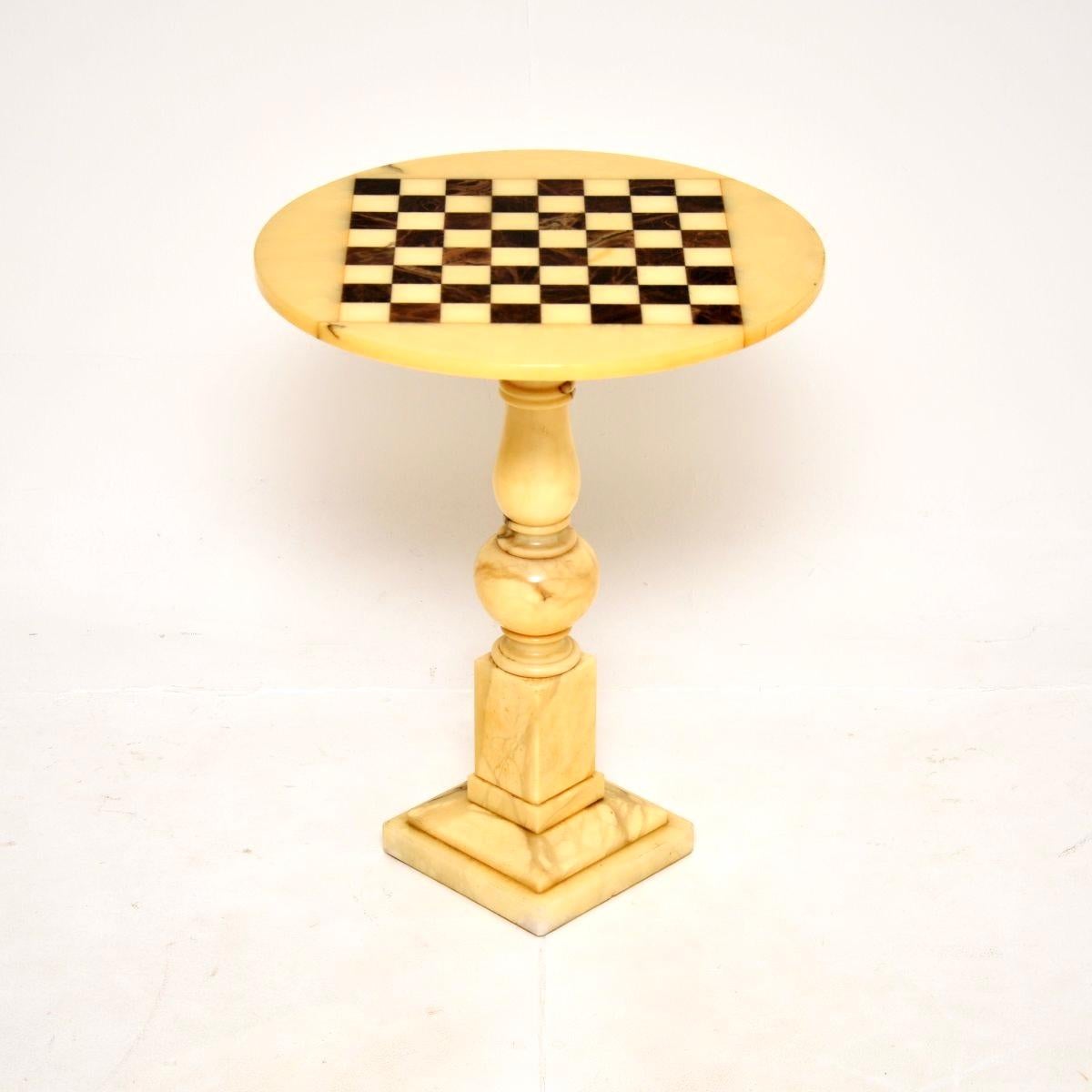 A beautifully made and very stylish antique solid marble chess table. This was made in England, we would date it to around the 1950’s.

It is of outstanding quality, the circular top is inlaid with contrasting checkered colours of marble which make