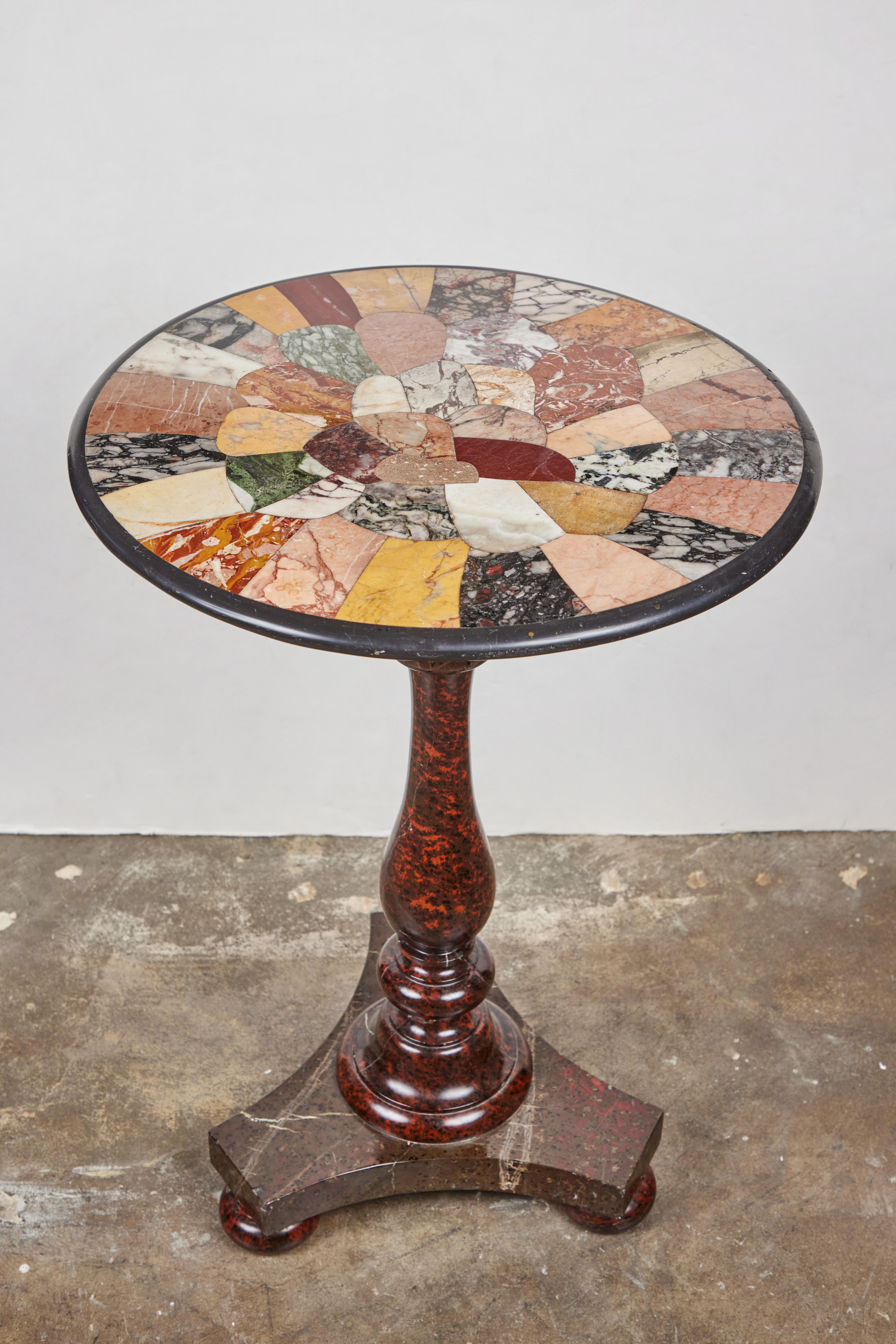 A. c 1860, Italian, hand-carved and polished, solid marble pedestal table. The vibrant, specimen top above a turned center column on a tripod base with bun feet.