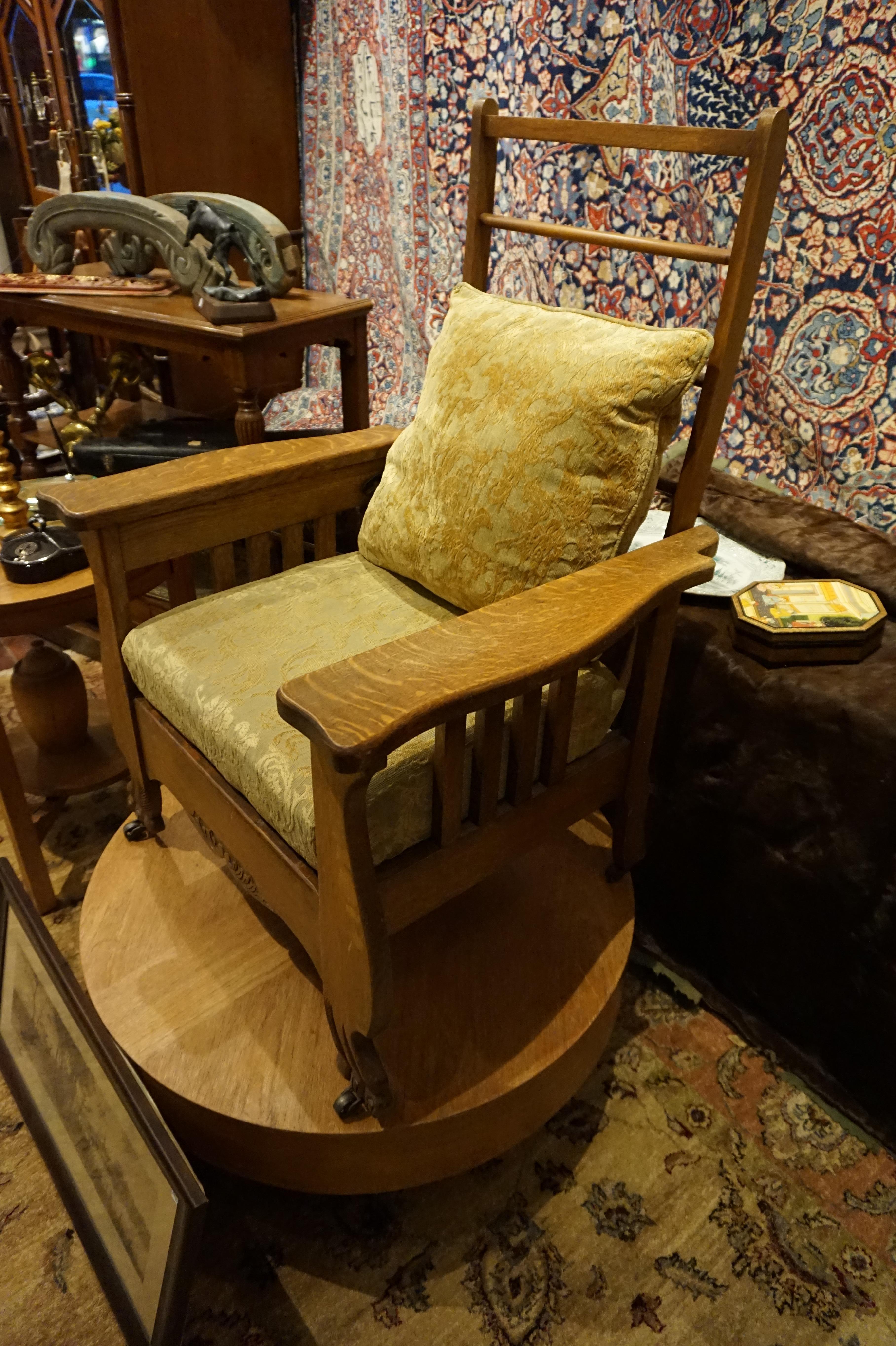 Canadiana Morris chair with label. Solid oak construction. Carved paws on feet and casters. Adjustable back mechanism,

circa 1900-1910.