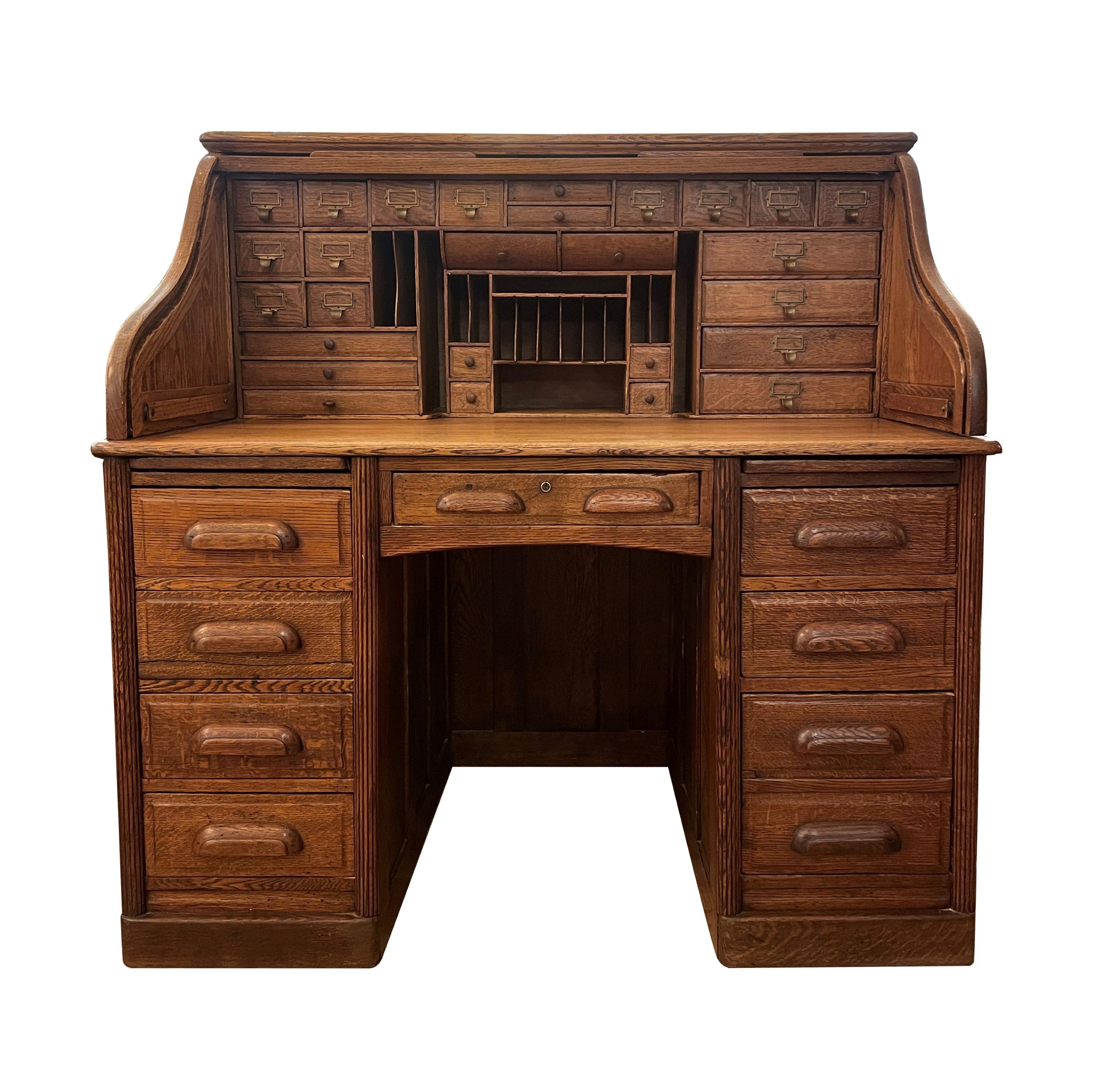 Antique oak roll top desks are exquisite treasures, showcasing intricate craftsmanship, sturdy construction, and a wealth of storage options with drawers and cubbies, perfect for organizing and displaying cherished items. This desk can be moved in