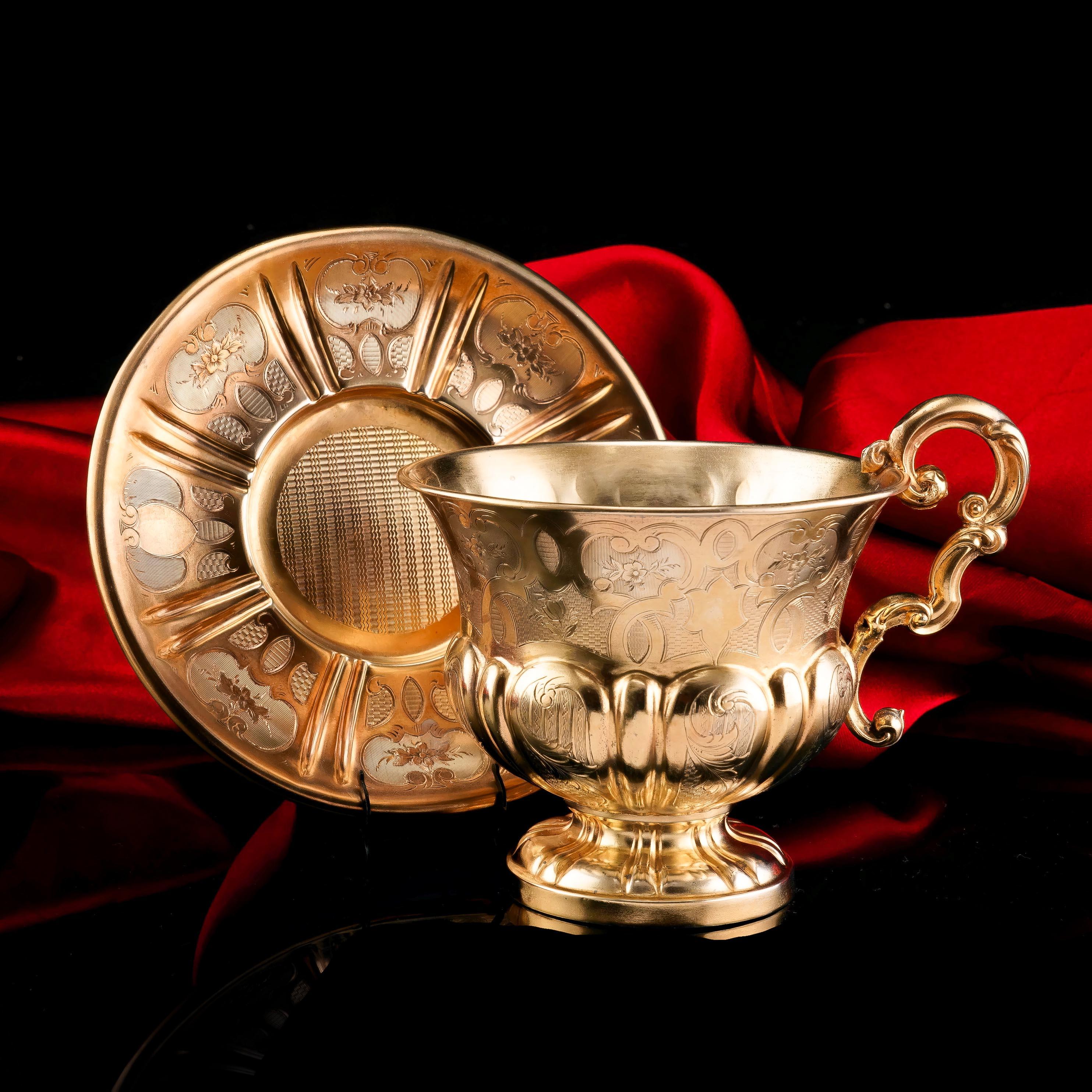 We are delighted to offer this magnificent solid silver gilt cup and saucer made c.1880s, possibly French. Both pieces are unmarked leaving us only with clues such as their shape and engraved decorations to deduce their age and origin, however, we