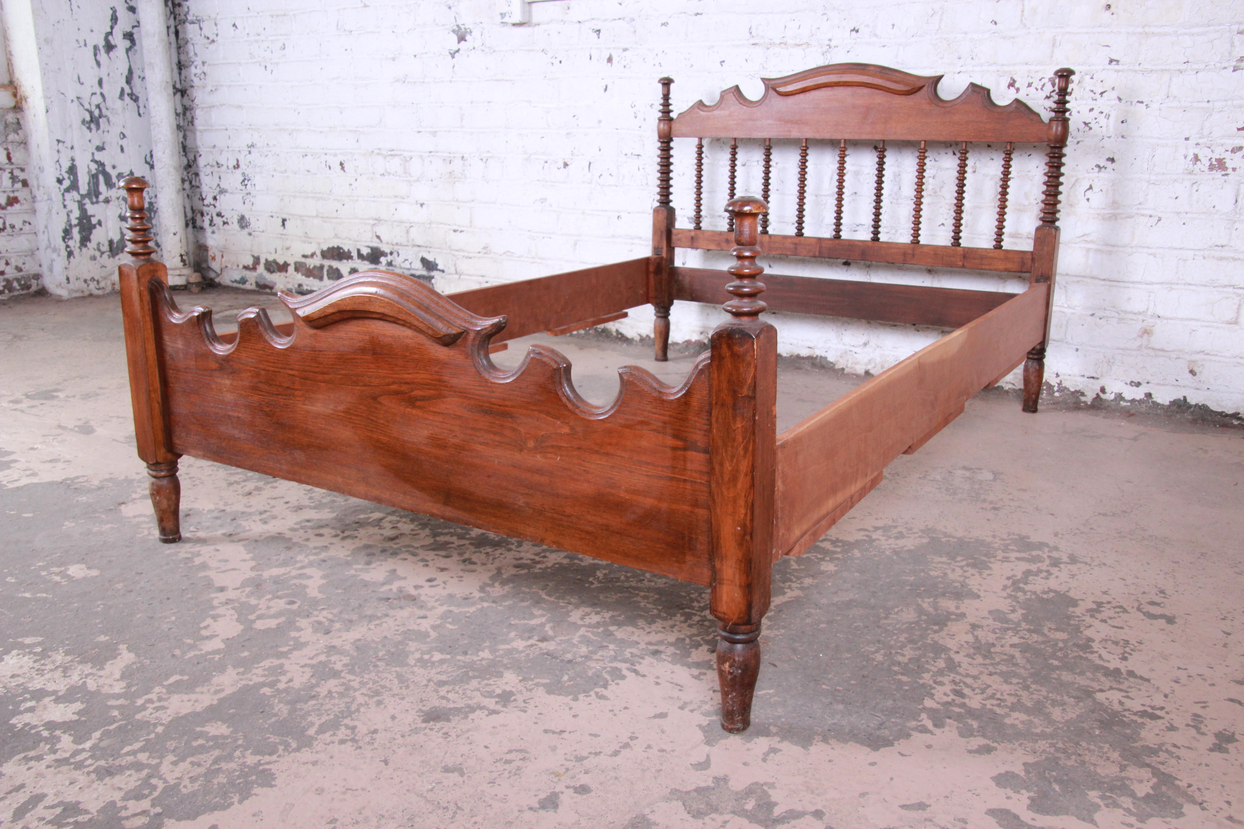 A beautiful carved walnut Jenny Lind spindle bed. The bed has gorgeous walnut wood grain and nice carved wood details. Assembled it measures 52