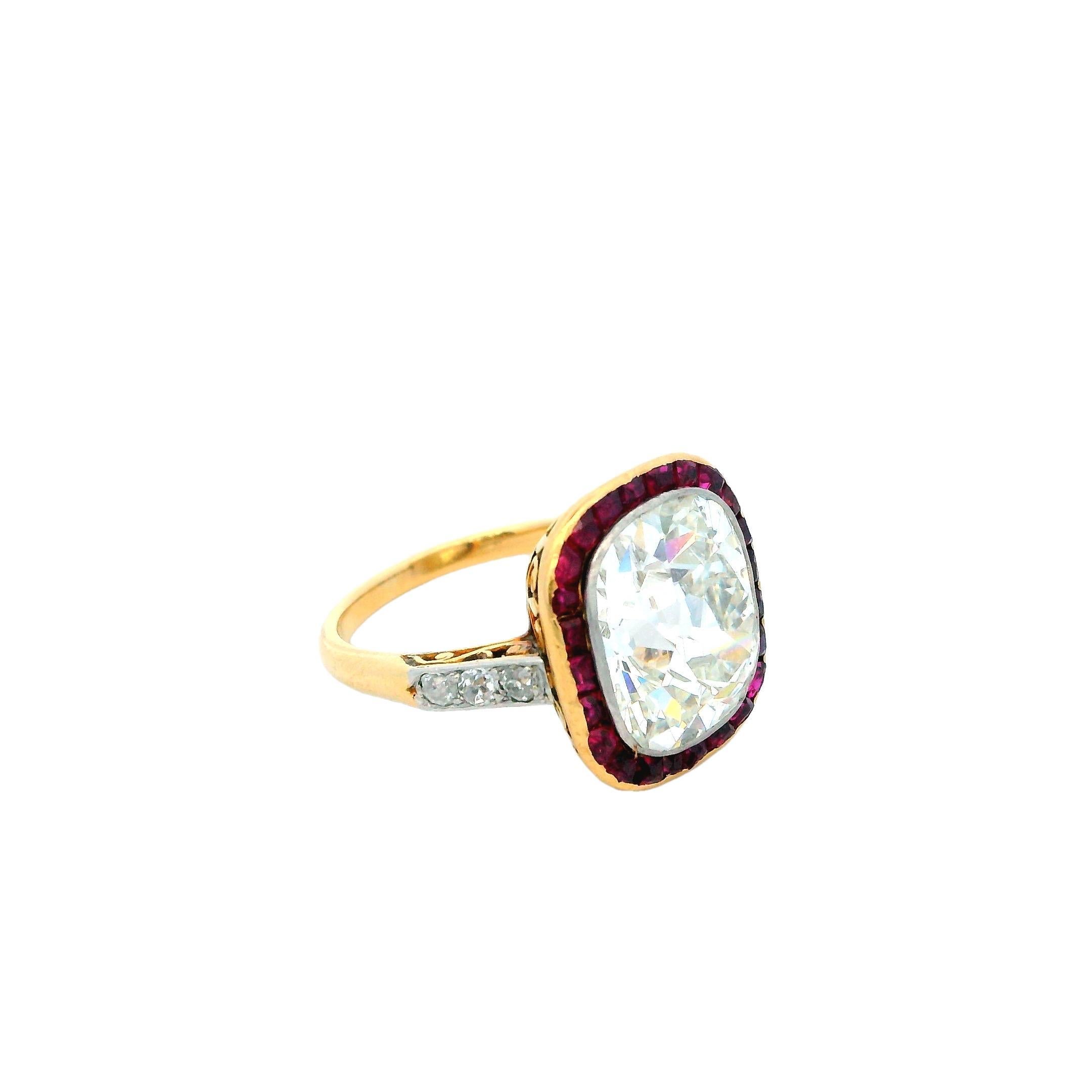 This exquisite ring showcases a stunning 4.92-carat antique cushion-cut diamond, known for its timeless charm and brilliant white hue. The diamond is elegantly framed by 1.0 carat of French-cut rubies, providing a striking contrast with their vivid