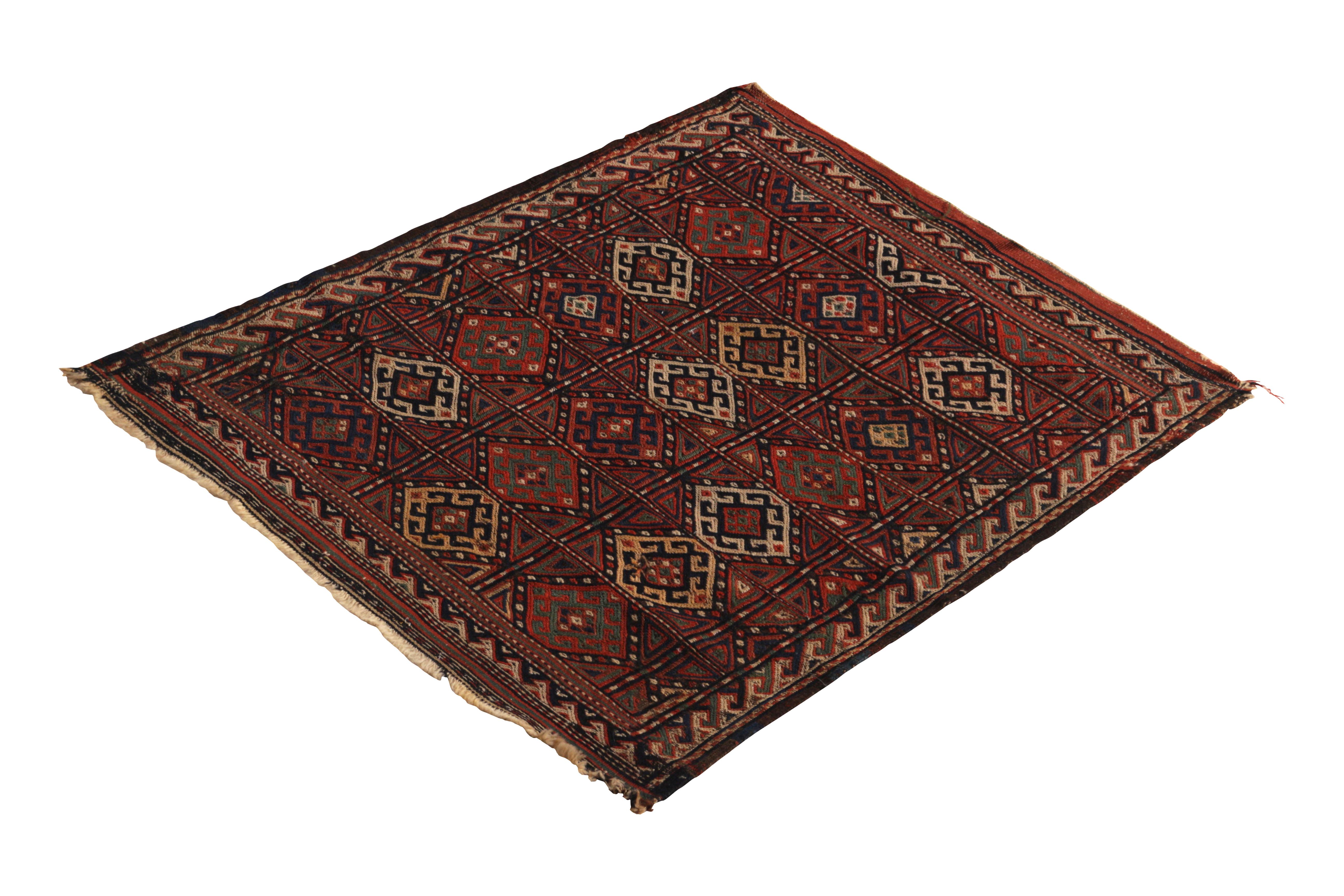 Handwoven in wool originating from Russia circa 1890-1900, this antique Kilim rug connotes a rare small-sized Sumak (also spelled Soumak) tribal design in conversely Classic red and blue hues favored in this era and region. Connoisseurs will note