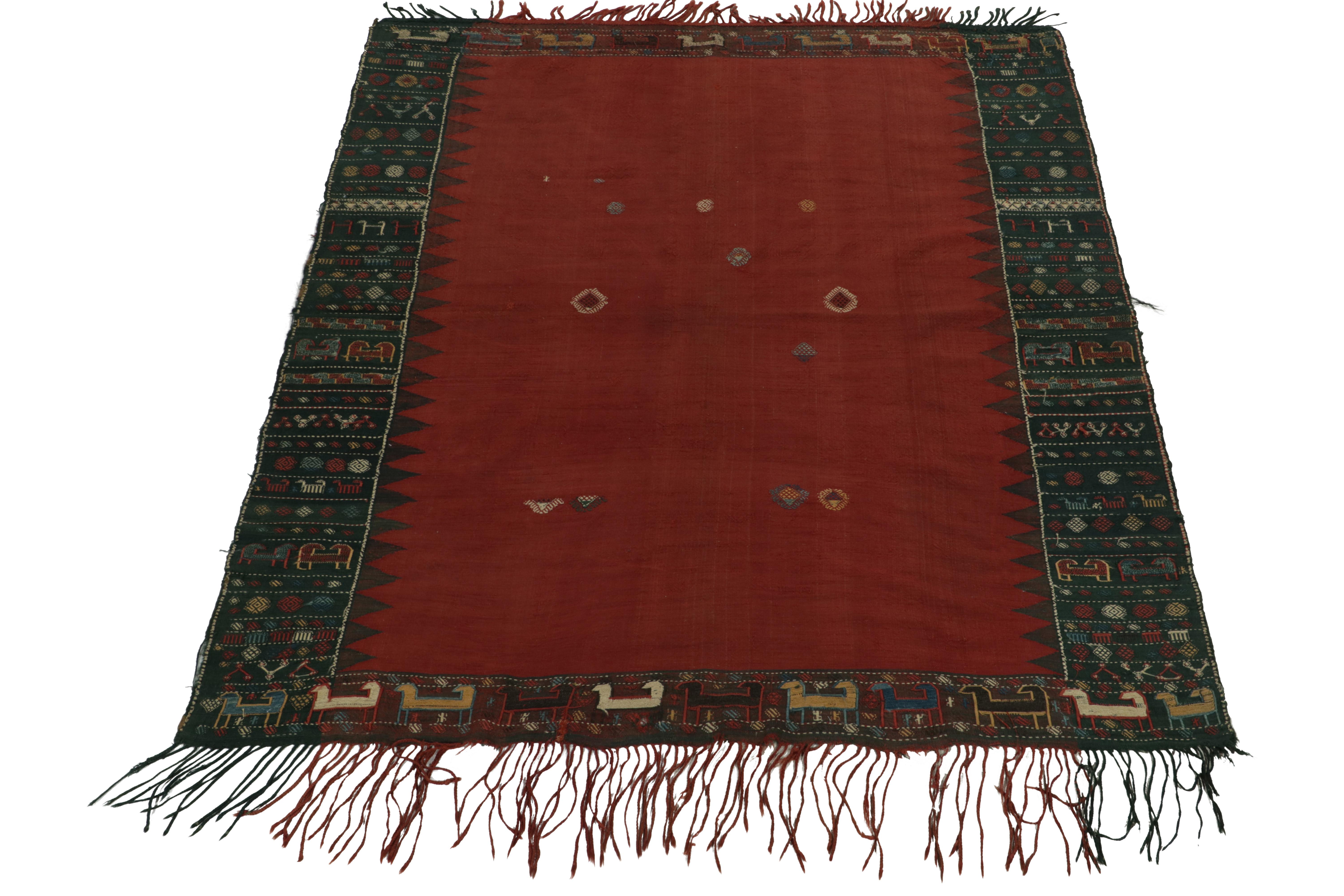 From our celebrated flatweave collection, a 5x7 antique Soumak kilim rug originating from Russia circa 1910-1920. The collectible opts for minimalism in the near-open field relishing rich red & black for an intriguing depth in the border amplifying