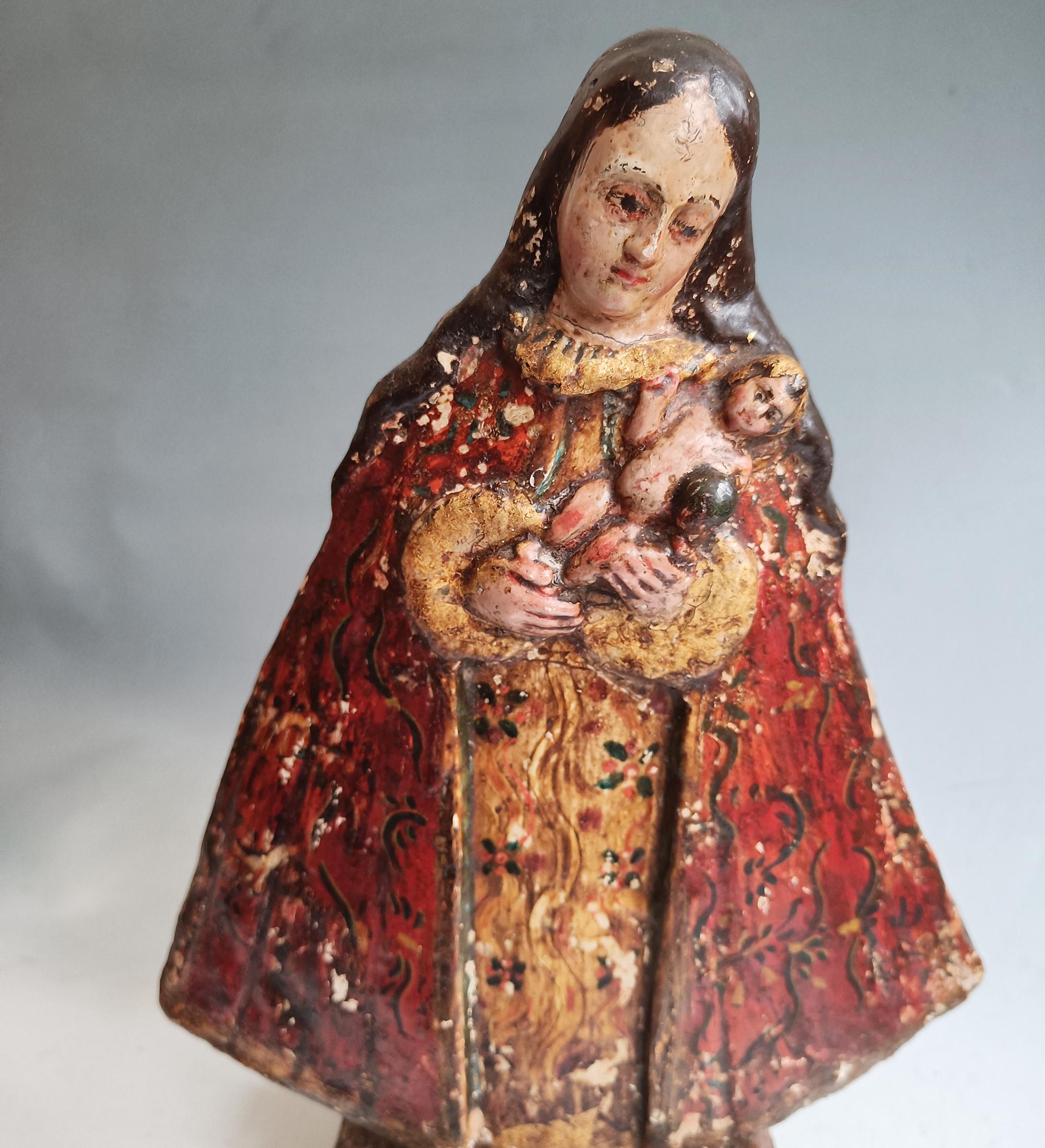 Spanish Colonial Madonna and Child
Peru or Bolivia, late 18th – early 19th century

A finely carved Andean polychrome wood figure of the Virgin and Child, the Virgin shown in a characteristic conical form with richly decorated red and gold mantle