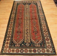 Antique South Caucasian Kazak with two elongated latch hook medallions.