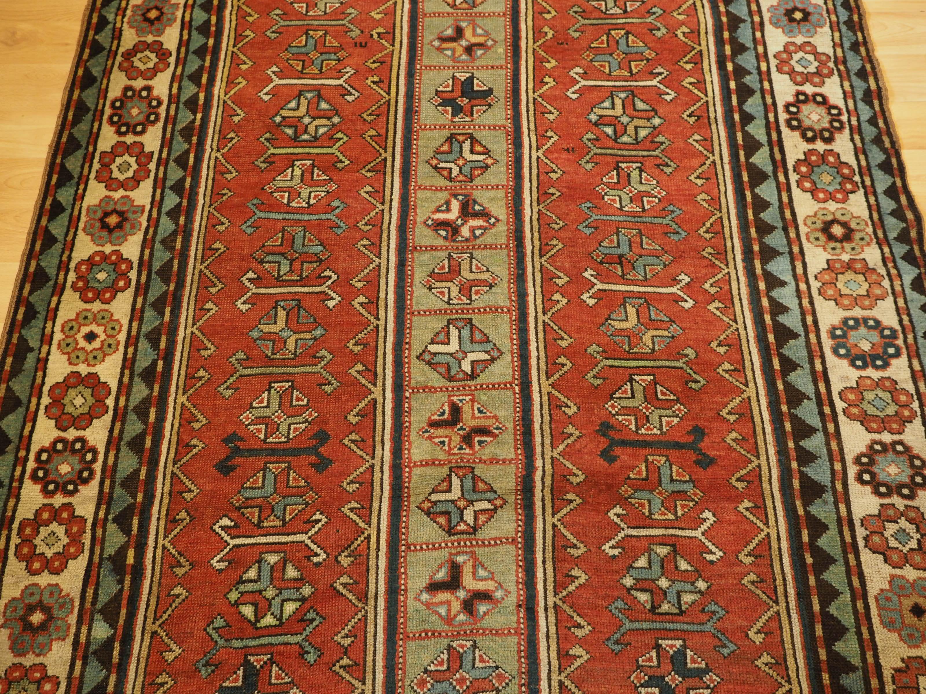 Wool Antique South Caucasian Kazak with two elongated latch hook medallions. For Sale