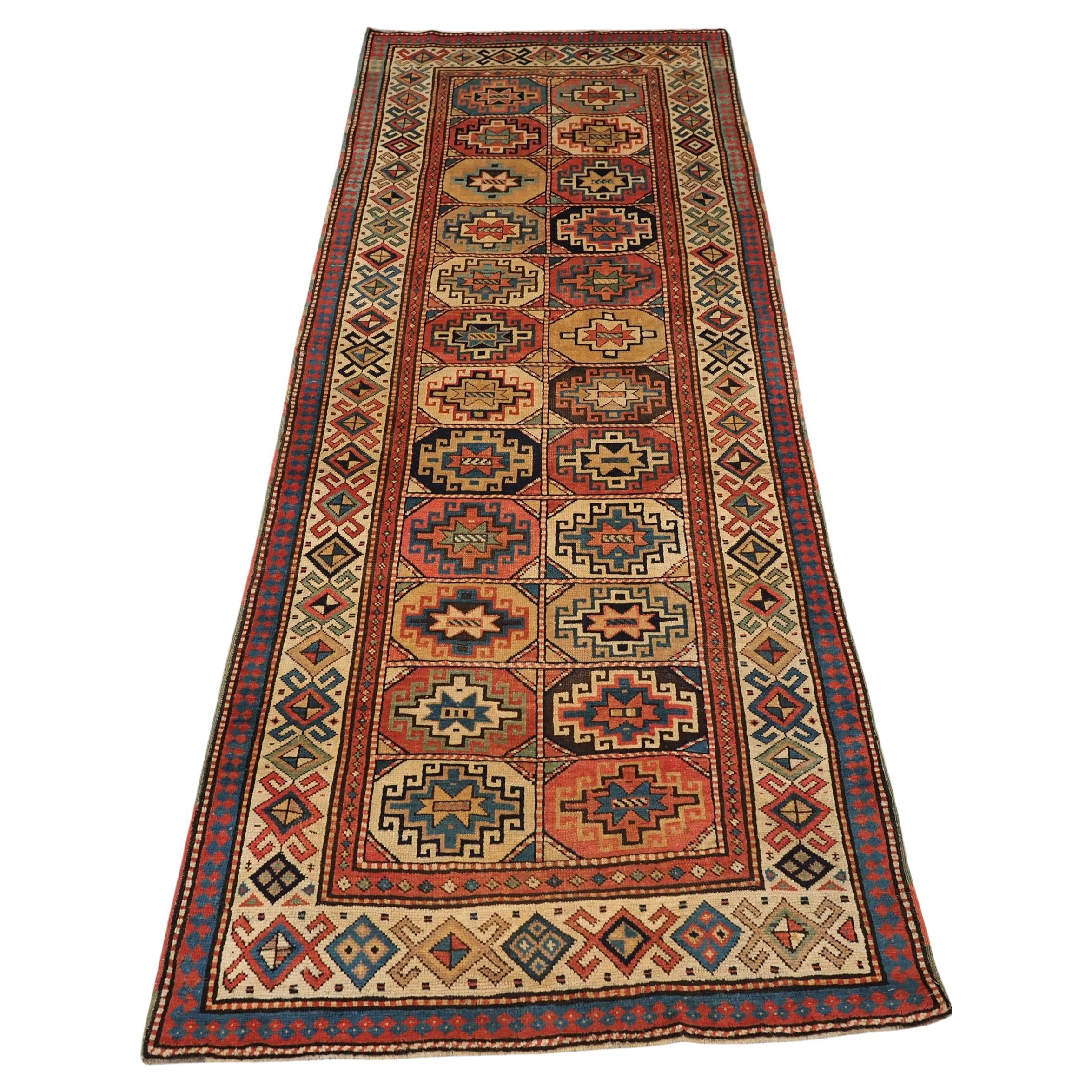 Antique South Caucasian Moghan Kazak long rug with Memling guls within octagons.