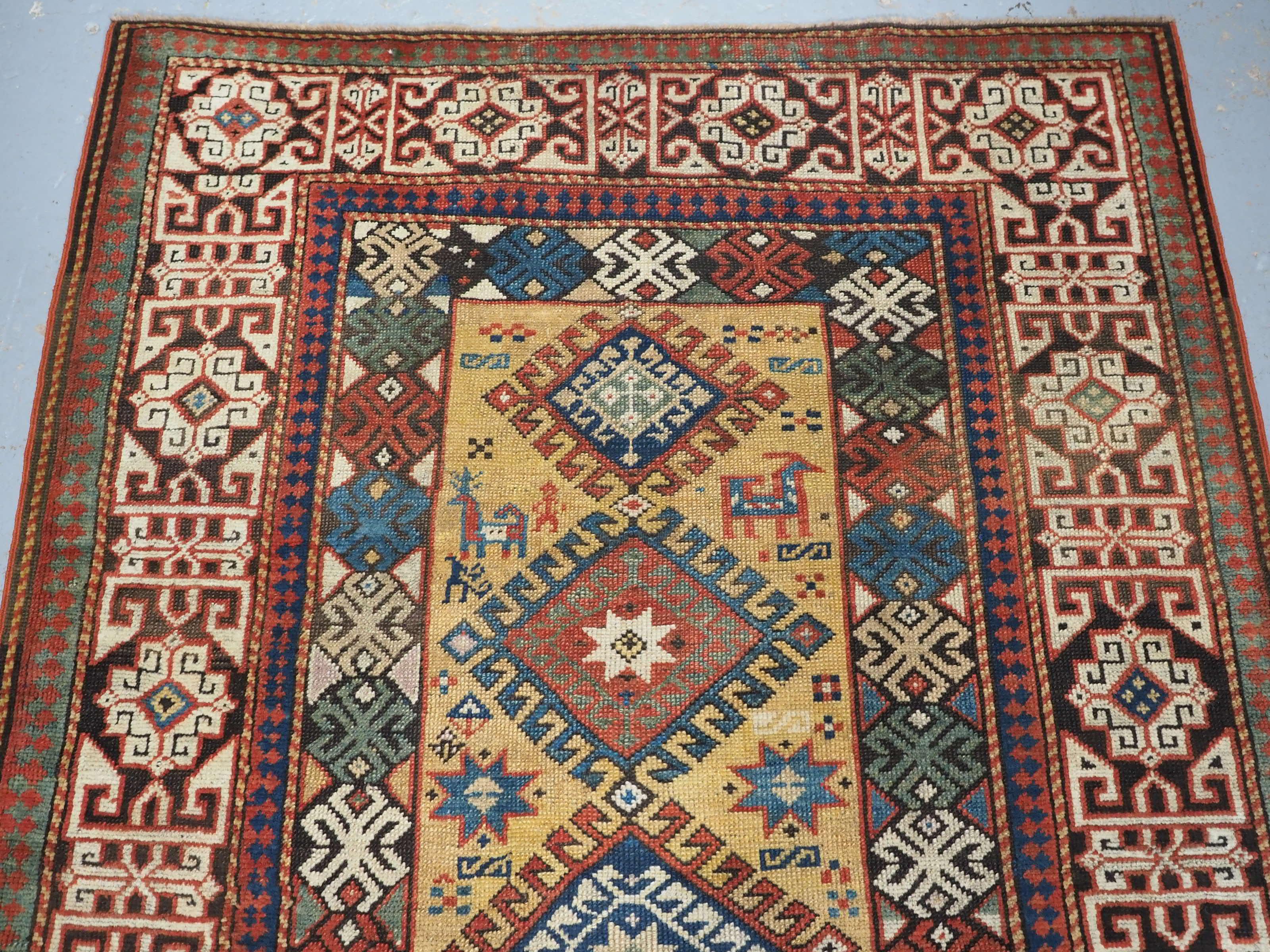 Size: 7ft 5in x 4ft 2in (226 x 126cm).

Antique South Caucasian rug with scarce yellow ground.

Circa 1880.

This is an outstanding rug with a clear yellow ground containing six multi coloured diamond shaped latch hook medallions, each centred with