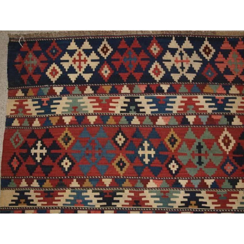 Antique South Caucasian Shirvan kilim of outstanding colour and traditional banded design. A very good example of type, with a banded design and small hooked medallions, the colour palette throughout is superb and gives the kilim a light feel. The