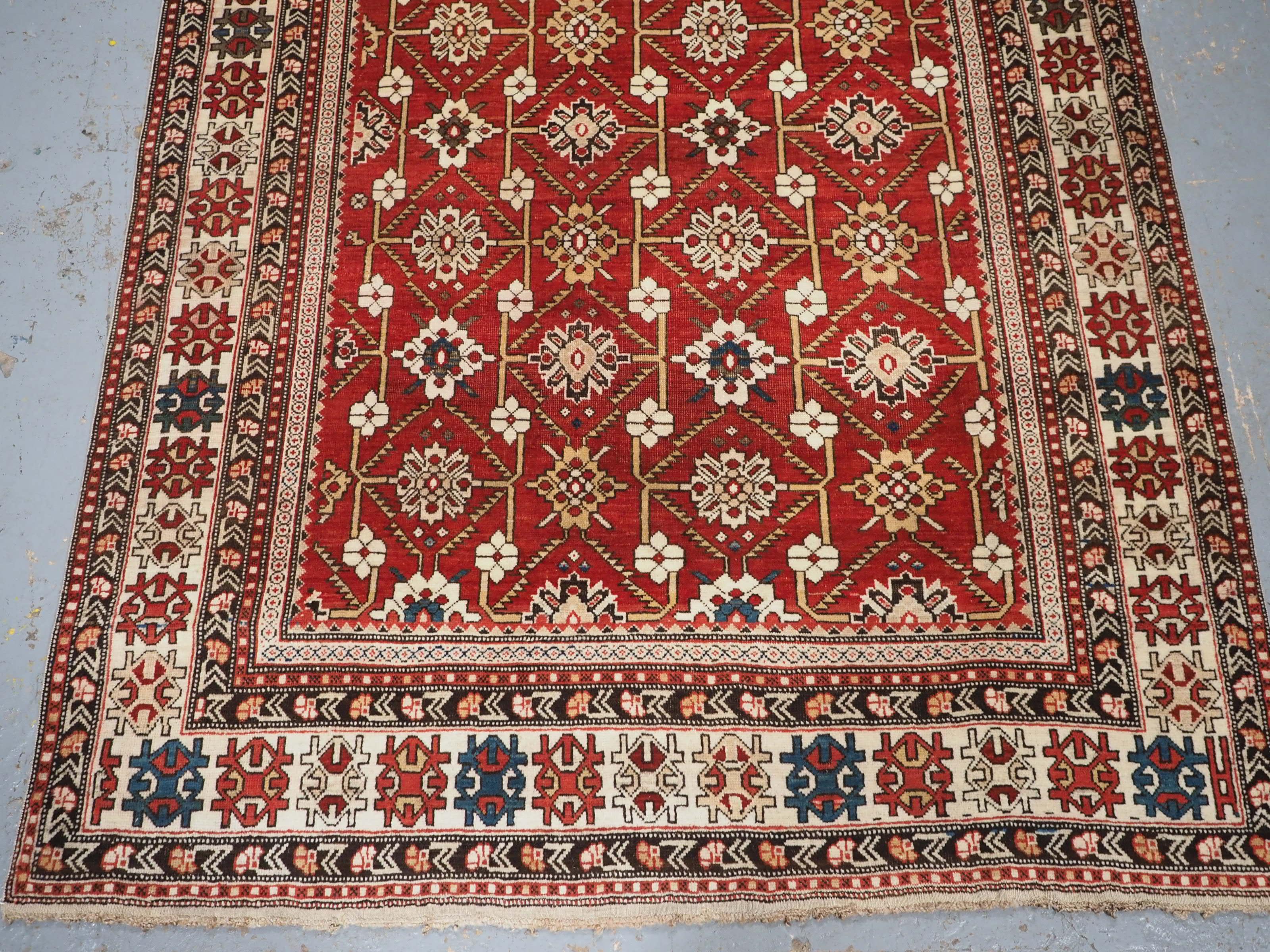 Early 20th Century Antique South East Caucasian Shirvan rug with bold floral lattice design. For Sale