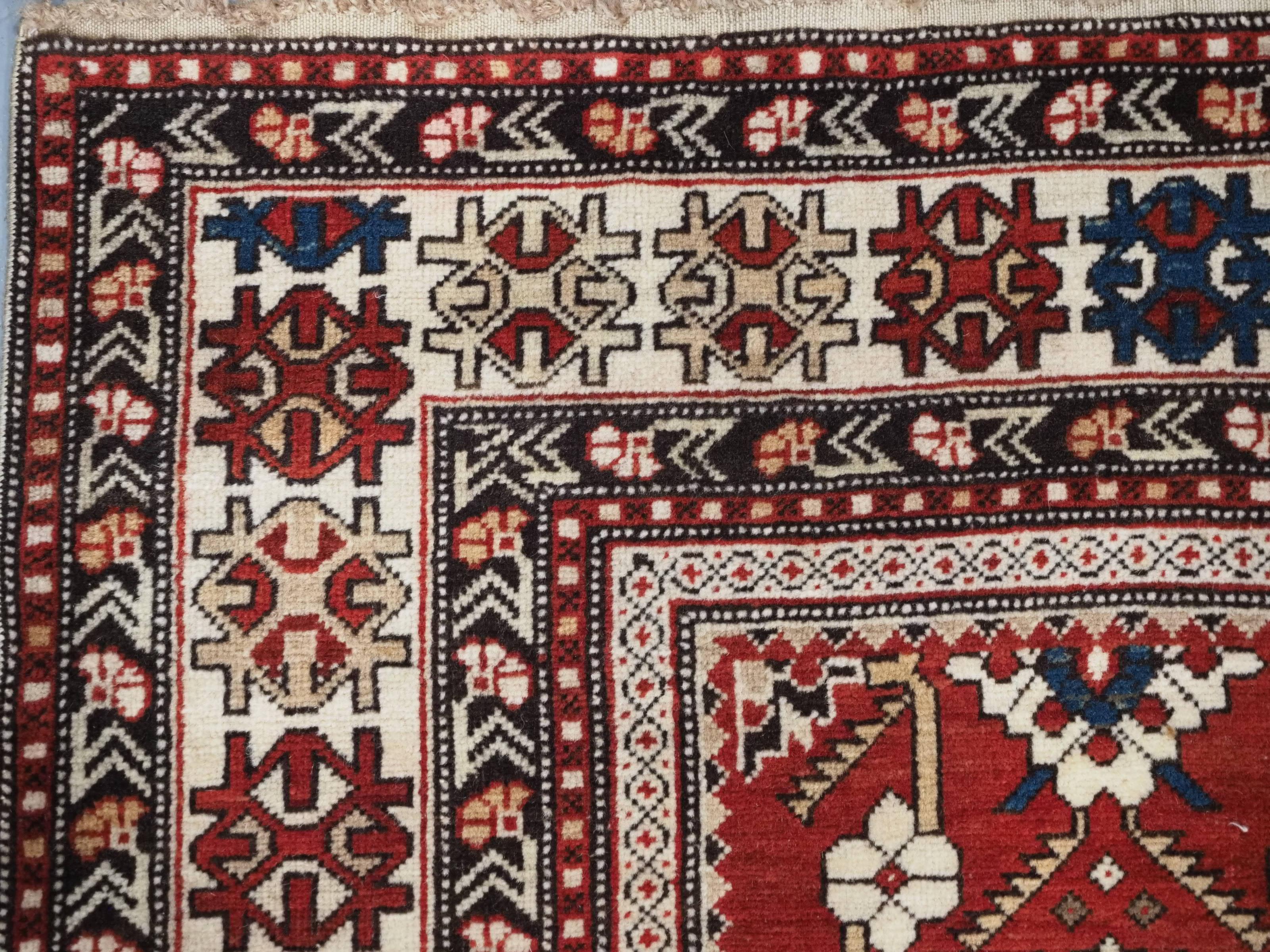 Wool Antique South East Caucasian Shirvan rug with bold floral lattice design. For Sale