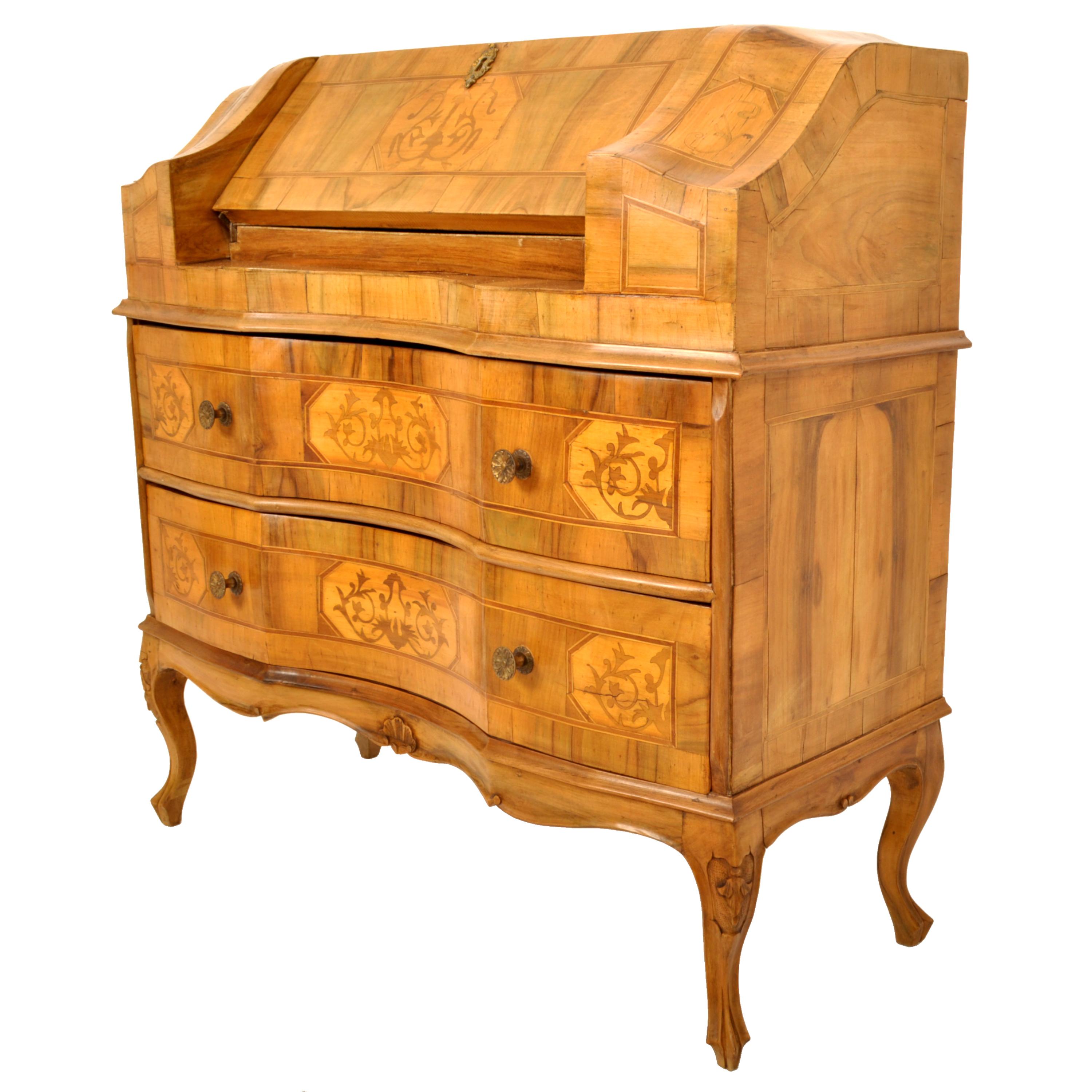 A good antique 19th century South German marquetry walnut & fruitwood inlaid desk, circa 1850.
The desk of serpentine shape & having a fold out desk writing surface which encloses drawers and a pigeonhole, below are twin drawers of serpentine shape