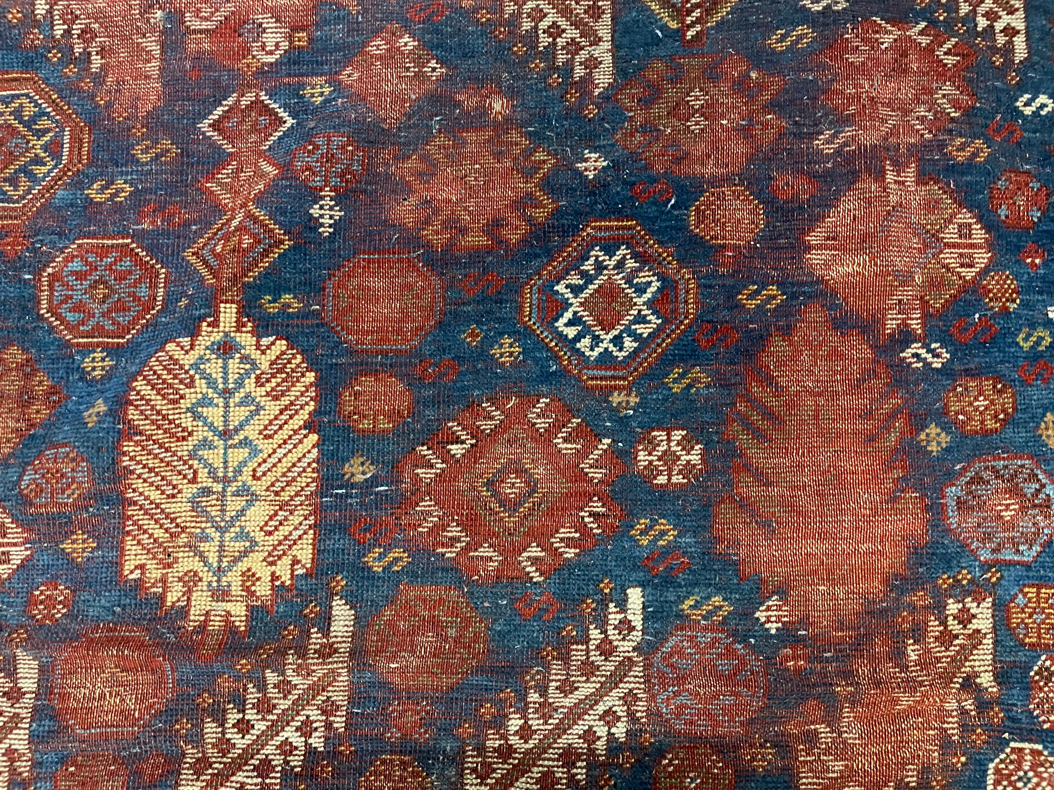 
Antique South Persian Afshar Rug
Second half 19th Century. 
The center blue field with allover geometric motifs and stylized trees, within a white border with alternating darts and octagonal medallions, ends with additional narrow borders.
(heavy