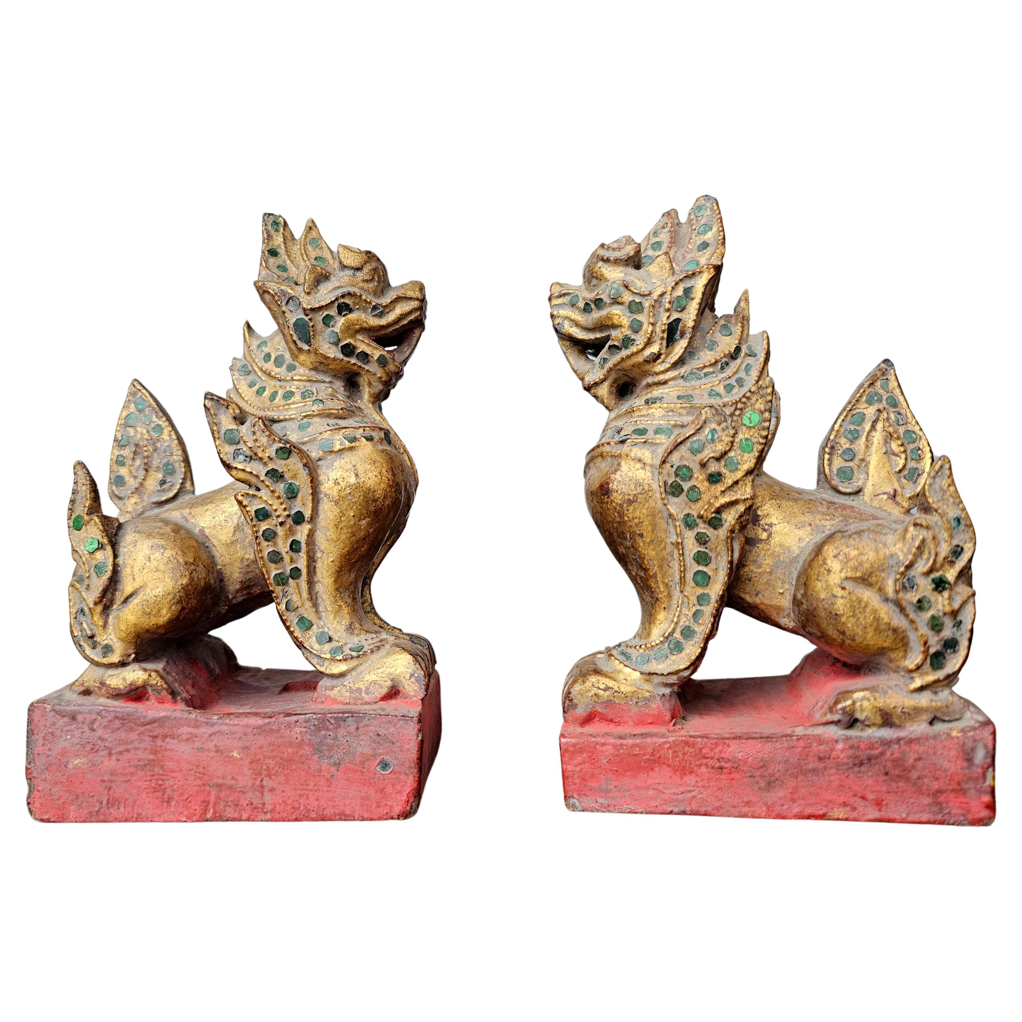 A near pair of antique Southeast Asian Burmese jeweled parcel gilt wooden temple guardian figure carvings. circa 1900

Hand carved in Burma (present day Myanmar) in the late 19th / early 20th century, most likely the Mandalay region, each richly